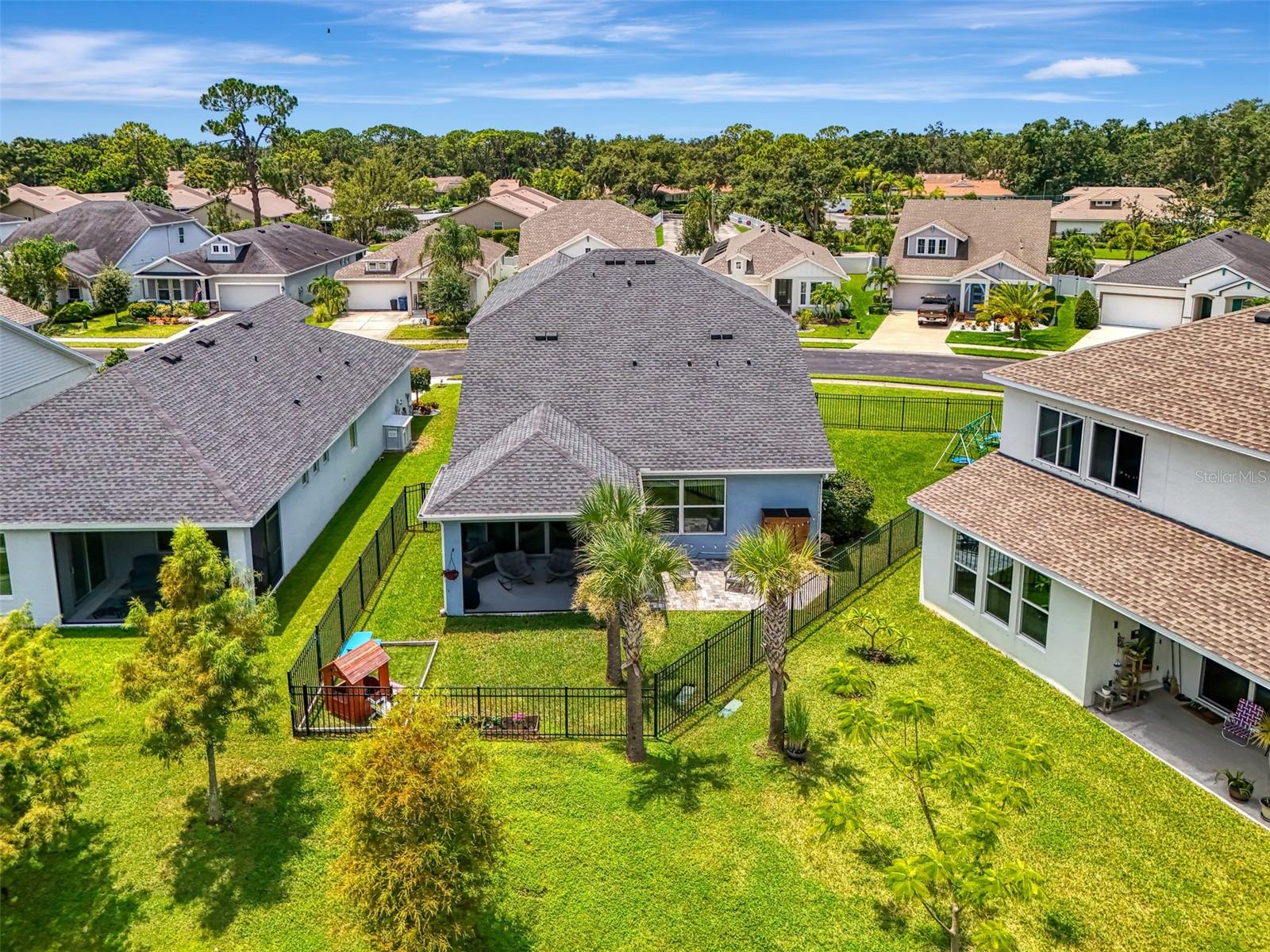 Welcome to one of the largest homesites in Moss Creek—an oversized corner lot with serene water views and rare HOA-approved full-yard fencing and play gym already in place. This spacious two-story David Weekley Homes Alstonia model offers 4 bedrooms plus a den, 2.5 baths, and a host of thoughtful upgrades designed for comfort and style. Step inside to find no carpet on the first floor—just durable, scratch- and water-resistant luxury vinyl plank flooring that flows seamlessly through the main living areas. The first-floor living room and primary suite both enjoy peaceful water views, while the bathrooms feature tiled showers that extend to the ceiling for a clean, modern finish. The kitchen is a true centerpiece, with sleek quartz countertops, Whirlpool appliances, and a layout that invites both cooking and conversation. Outside, enjoy Florida living at its finest with a screened-in lanai, uncovered paver patio, covered front entry, and a fully irrigated, beautifully landscaped yard. Unlike most homes in the community, this property includes gutters and a full smart home system with integrated lighting and perimeter security. Auto-on lights in the garage and half bath add convenience, while the triple-lite UV HVAC system ensures purified air throughout the home. The garage is a standout feature, with paint chip epoxy floors, overhead storage, a Fast Track system with attachments, and a 50 AMP hook-up for added versatility. Inside, you'll find a custom primary closet, laundry shelving, and two HOA-approved sheds—plus a playset ready for fun. As a bonus, the survey and title insurance are included at no additional cost at closing, offering peace of mind and real savings. Residents of Moss Creek enjoy access to a community pool, perfect for relaxing weekends and neighborhood gatherings. And with nearby public golf courses, grocery stores, restaurants, Sam’s Club, University Town Center, and world-class Gulf beaches, this home delivers the perfect blend of comfort, convenience, and lifestyle in one of Bradenton’s most desirable communities.