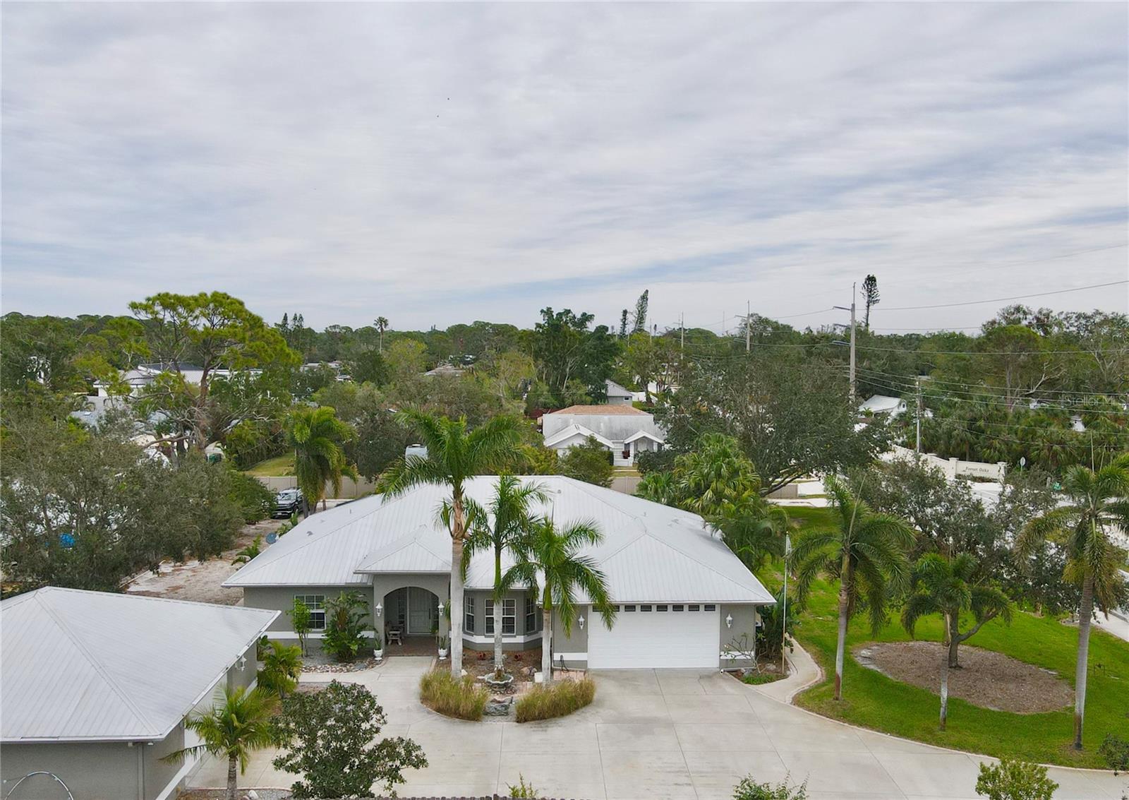 Motivated Sellers! Enjoy Florida at its best with no compromises. This one of a kind 3 bedroom 3 bath 4 car garage, quality Hurricane rated custom home is perfectly situated on almost an acre! (non-deed restricted) Minutes (biking distance) from world famous Siesta key beaches, shopping, restaurants', schools, parks and more. The custom interior features will blow you away! This open air floor plan includes a gourmet/chefs Eat-in kitchen, Large island w butler sink, separate dinning room, massive bedrooms, an oversized living room with Gas/wood burning fireplace, vaulted ceilings, natural pine tongue and groove kitchen celling, hard wood floors, full home patio access, private study, oversized primary suite and so much more. The unique exterior upgrades include a screened in enclosed pool/swim and paver patio, an open air paver patio, metal roofs, a irrigation well, Irrigation system, an extended concrete drive leading to a huge detached two car/boat garage and the front patio with an additional oversized attached two gar garage. Bring your toys because this near acre lot also includes a massive shelled paddock perfect for the largest of boats and or recreational vehicles. The exterior landscaping is exquisite complete with exterior landscape lighting to show off the beautiful mature and natural Florida landscape features. This home provides you with a unique opportunity to experience the rural type of lifestyle in the center of Sarasota close to the beach without restrictions or pesky HOA's. Don't wait! call to schedule your appointment today!