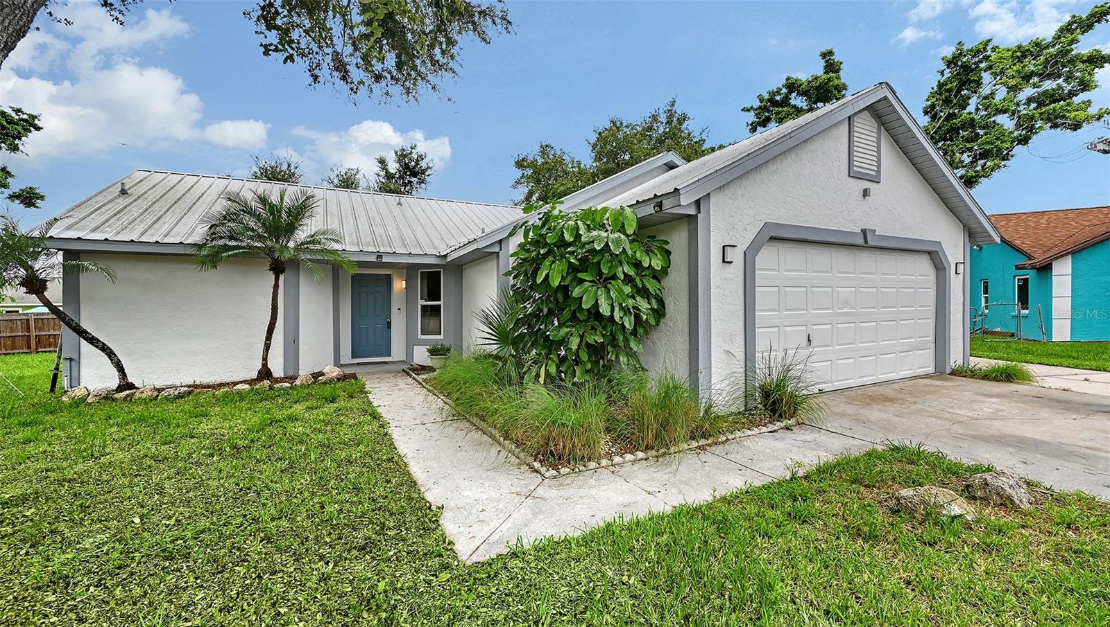 Check this one out! Updated throughout this lovely home offers the NEWS. New laminate flooring, newer stainless appliances, kitchen “shaker” cabinets, granite, vanities in both baths & more. Roof 10-12 years old, water heater 2018, A/C 4-5 years old and a Square D electrical box. Cathedral ceiling in Living room. Large glass enclosed lanai, overlooks partially fenced back yard.
Don’t miss the parking pad to the right of the oversized garage, separate shed too. Well for irrigation unsure if it’s working. Close to schools, easy to see.