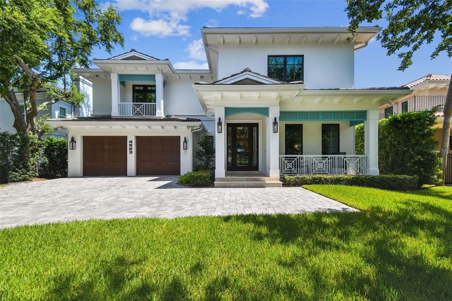Located in one of Tampa's preeminent neighborhoods, Beach Park, this newer custom-built Matt Hall TamBay home sits on a quiet dead-end street. This home showcases transitional coastal architecture, refined finishes, and thoughtful design throughout. Step onto the covered front porch, framed by Bevelo gas lanterns, and enter through a hurricane impact-rated door into a bright, welcoming foyer. To your immediate right, a private office offers a quiet retreat with a Heat & Glo gas fireplace and recessed lighting. Across the hall, the formal dining room sets the stage for gatherings, flowing effortlessly toward the heart of the home. The kitchen anchors the main living space, featuring striking quartzite counters, Sub-Zero and Wolf appliances—including a gas cooktop with griddle and pot-filler faucet—bar seating, a walk-in pantry, and a dry bar with wine fridge. Coffered ceilings and recessed lighting add architectural detail, while the open floor plan leads into the living room, centered around a gas fireplace and framed by French doors opening to the travertine-covered patio and pool deck. Out back, enjoy the heated saltwater PebbleTec pool with a robotic sweep, surrounded by a private, spacious outdoor living area ideal for entertaining. Also on the main level is a thoughtfully placed guest suite, offering two walk-in closets and a full marble-tiled bath with a walk-in shower—conveniently positioned to also function as a pool bath. Upstairs, four additional bedrooms include a spacious primary suite. The owner’s retreat features a spa-inspired bath with two separate vanity stations, a soaking tub, linen closet, private water closet, and a 21x11 walk-in closet with two island dressers. Two secondary bedrooms share a Jack-and-Jill bath with dual sinks, a private washroom, soaking tub, and marble walk-in shower. The fourth upstairs bedroom is currently configured as a media room, complete with projector, movie screen, en-suite bath, and a wet bar—perfect for entertaining or relaxing movie nights. Additional highlights include impact-rated windows and doors, tile roof, 2-story block exterior, two tankless water heaters, a Control4 sound system throughout, and an oversized two-car garage with room for storage solutions. Minutes to Hyde Park, Soho, Downtown, TIA, International Mall, wonderful restaurants, shopping and the Gulf beaches. Schedule your private viewing today!