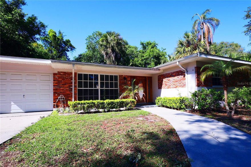 One or more photo(s) has been virtually staged. Set in the heart of Swann Estates, this elegantly renovated 3-bedroom, 2-bath home sits on a tranquil, tree-lined street just moments from Beach Park. Thoughtful upgrades include new flooring and refined kitchen countertops, blending modern comfort with timeless charm. Zoned for the coveted PLANT/COLEMAN/GRADY school district and ideally located near downtown and premier shopping. The light-filled living and dining spaces showcase large picture windows, while the private primary suite offers generous closets, an en-suite bath, and French doors opening to a serene backyard retreat. An oversized tandem garage accommodates up to three vehicles, with optional EV charger installation available.