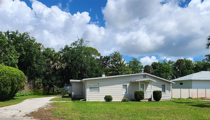 Cute cottage nestled in a mature neighborhood on a double lot in Edgewater Highlands. This is the last large parcel with recent neighborhood sales and pending sales at $650,000.00 and above. There is opportunity here, a new build would offer south and east views of the river. Western shade with a mature oak keeps the site cool and private. The cottage is a 2 bedroom with a large primary, updated bathroom with walk in shower. A cozy living room, galley kitchen, a dining room nook. a rear compact porch and a separate laundry room with storage and attached garage, Close to Riverside Drive walks, boat ramps, parks and all that New Smyrna Beach has to offer.
A potential new 2 story build could include a port cochere allowing a detached garage with living quarters above in the rear corner and views of the river from a south facing primary suite.