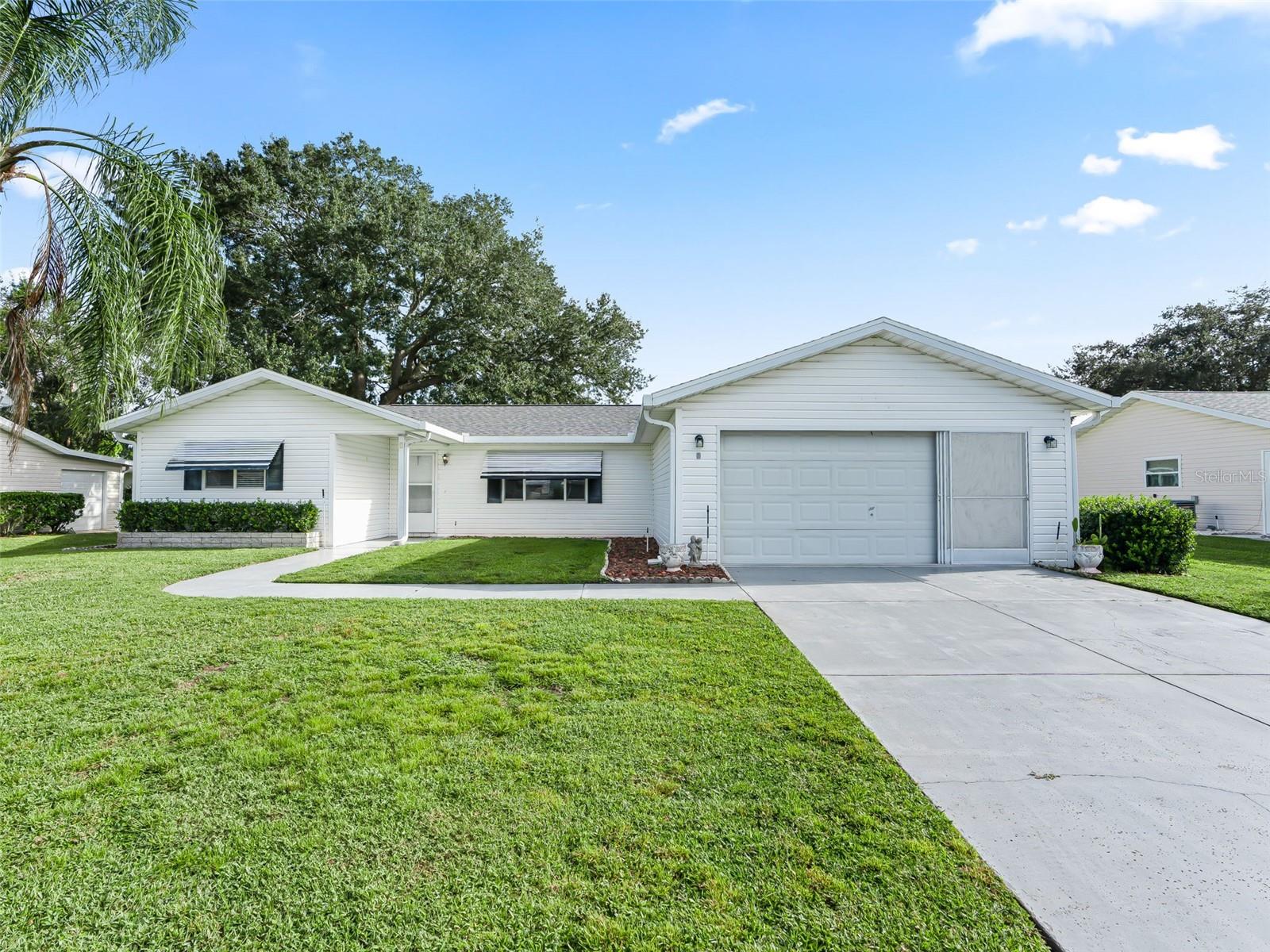 One or more photo(s) has been virtually staged. Welcome to Spruce Creek South, a 55+ gated Golf Community in a prime location offering the perfect blend of comfort, convenience, and life style close to The Villages, restaurant's, medical, and shopping. Spruce Creek South offers numerous clubs, social events, pool, and fitness area just to name a few. Whether you are looking for a full-time residence or a seasonal retreat, this charming Holly model is slightly larger than most Holly plans. Split 3 bedroom 2 bath provides the ideal space for guest, home office or hobby room. Spacious open concept floor plan with a Cathedral ceiling, an indoor laundry room, and two car garage. The primary suite includes a walk in closet and private en-suite bathroom. Enjoy relaxing on your lanai or sitting out on the screened bird cage. Home has an added storage area that is connected to the bird cage. Roof 2023, HVAC 2015, Clothes dryer 2023, indoor/outdoor carpet on the lanai 2025. Schedule your private tour today!