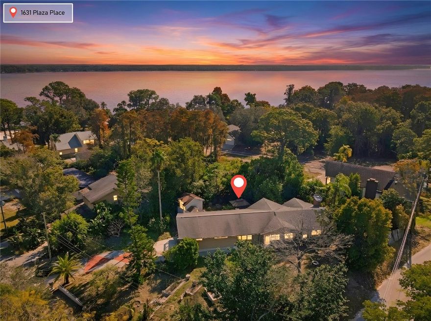 One or more photo(s) has been virtually staged. From the moment you arrive, 1631 Plaza Place feels like a hidden retreat—nestled on a high-and-dry, oversized corner lot near Lake Tarpon, where mature landscaping, natural light, and timeless character set the stage for something truly special. Step up the beautifully landscaped stairs and pathway and through the front door, where charm, space, and opportunity immediately welcome you home. Inside, you are greeted by the kitchen, thoughtfully positioned at the heart of the home. From there, the space opens into the stunning great room, featuring soaring wood ceilings, a wood-burning fireplace, and expansive windows that frame serene views of the surrounding property, with a subtle glimmer of Lake Tarpon visible through the trees. Abundant natural light fills the space, creating a warm and inviting atmosphere ideal for both everyday living and entertaining.

The primary suite offers a peaceful retreat, complete with its own wood-burning fireplace and an ensuite bathroom featuring a soaking tub, dual vanities, and plentiful natural light streaming through surrounding windows. On the opposite side of the great room, two additional bedrooms and bathrooms provide comfort, privacy, and flexibility for family or guests. This wing of the home also offers access to a deck and balcony overlooking the enchanting backyard—an outdoor setting that feels both private and serene.

The backyard is truly something special, featuring two fountains, thoughtfully designed gardens, chicken coops, and a paved area ideal for entertaining or relaxing outdoors. Mature fruit trees, including starfruit and orange trees, beautifully showcase the Florida lifestyle and add to the property’s unique character and charm.

Downstairs, a separate bedroom, bathroom, and bonus room offer exceptional versatility—perfect for entertaining, a game room, guest suite, or private retreat—with direct access to the large garage. This flexible layout enhances both livability and long-term potential.

Located near top-rated schools, historic and downtown Tarpon Springs, Sunset Beach, and Fred Howard Park, this property combines location, character, and opportunity in one rare offering. Ideal for investors or buyers seeking to customize a luxury residence, this home invites you to bring your vision to life and discover what makes this opportunity so special. Offered as-is, this property presents an excellent value-add opportunity with significant upside potential! Schedule your private showing today.