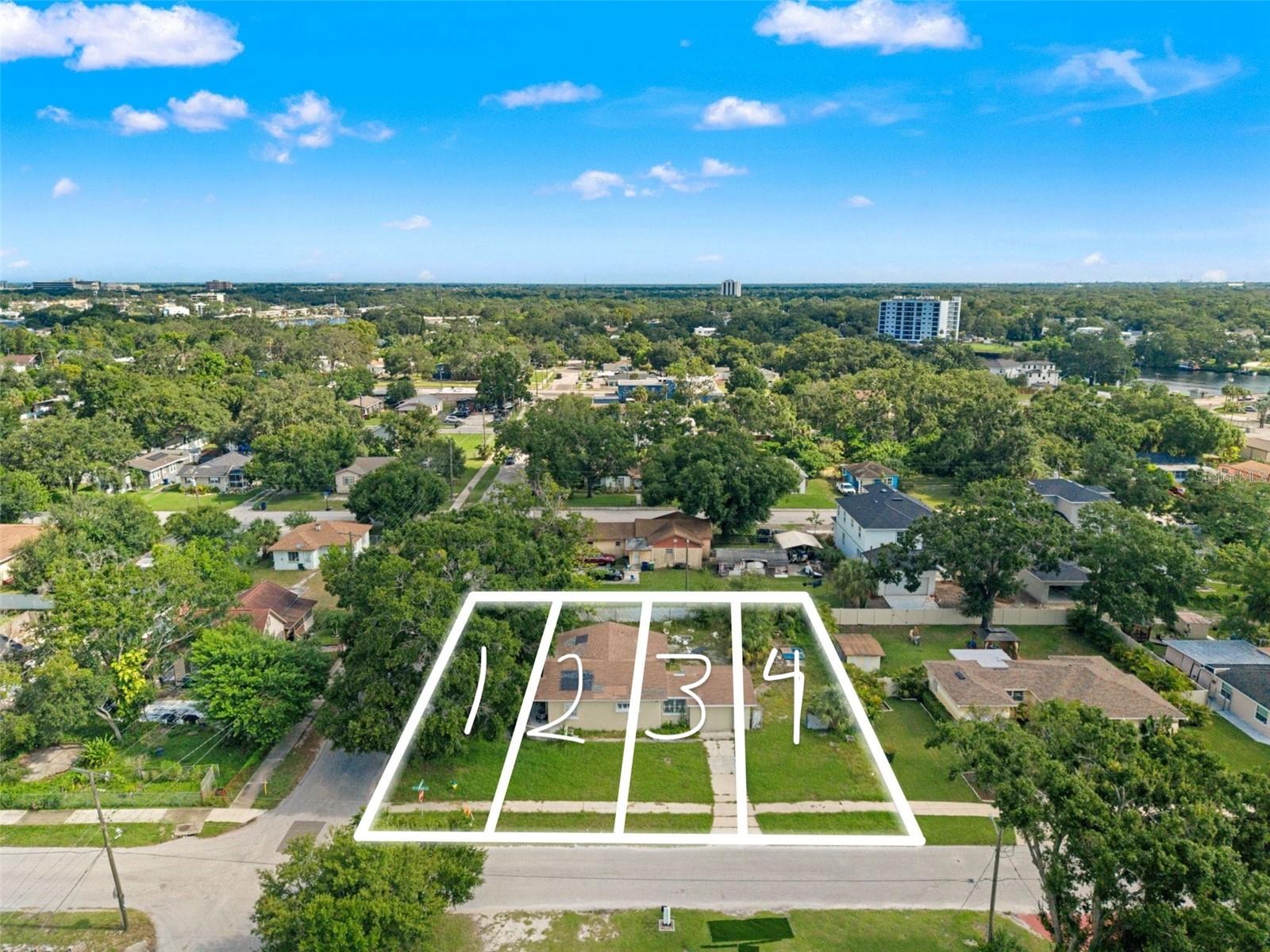 Lot #1, proposed address 2707 N Fremont Way, is a 30’ x 98’ corner lot in the heart of Old West Tampa, established through a fully approved PD rezoning designed for modern “shotgun” style homes up to 35 feet tall (3 stories). Setbacks allow for efficient layouts—5’ side yards, 13.5’ front, and 15’ rear—and the plans support homes in the 2,000+ heated square foot range. Each lot has space for two-car parking with alley access, so the front yard can be all about the porch experience.
This is one of four contiguous buildable lots (Lots 1–4, clearly labeled in the drone photos), and we prefer to sell as a package to allow a developer to create a pocket neighborhood where the design of each home elevates the value of the others. However, we are open to selling individually at the same price point. Lots 2, 3, and 4 are each 25’ x 98’ interior parcels and also available.
The location is surrounded by momentum—just blocks from the transformative Rome Yard redevelopment and the Tampa Riverwalk expansion, and minutes to Downtown Tampa and Armature Works. New construction nearby underscores the upside, with 1717 W Beach St selling for $975,000 and 1740 W Saint Louis St pending at $850,000.