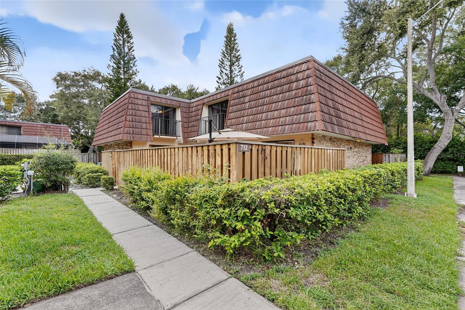 Welcome to this beautifully updated three-bedroom, two-and-a-half-bathroom townhome in the desirable community of Wedgewood of Palm Harbor. Every detail has been thoughtfully upgraded, making this home truly move-in ready. Major updates include a brand-new AC in 2024, a water heater in 2025, and an impact-rated front door installed in 2023. Step inside to find a spacious living and dining room combo with wood-look luxury vinyl flooring that flows throughout the home. The kitchen is a showstopper, completely remodeled with soft-close cabinets, granite countertops, a farmhouse sink, a stylish backsplash, new fixtures, a center island for prepping, and brand-new GE appliances. A half bath and laundry room with a new washer and dryer are conveniently located downstairs. Upstairs, the large primary suite feels like a retreat with its private spa-like bathroom featuring a fully tiled walk-in shower with a glass enclosure, a new vanity, sink, mirror, and fixtures. A spacious walk-in closet with custom organizers adds to the luxury. The two upstairs bedrooms each have its own private balcony overlooking the courtyard, while the downstairs bedroom features sliding glass doors that open directly to the courtyard. Enjoy the outdoors in your fenced front courtyard or take advantage of the many community amenities, including a large pool and spa, clubhouse, tennis courts, racquetball, basketball, a playground, and a scenic pond. Wedgewood of Palm Harbor is also close to top-rated schools, a variety of dining options, and just a short drive to the beautiful Gulf beaches. This townhome combines modern updates, comfort, and an unbeatable location, perfect for enjoying the Florida lifestyle. Schedule your tour today!