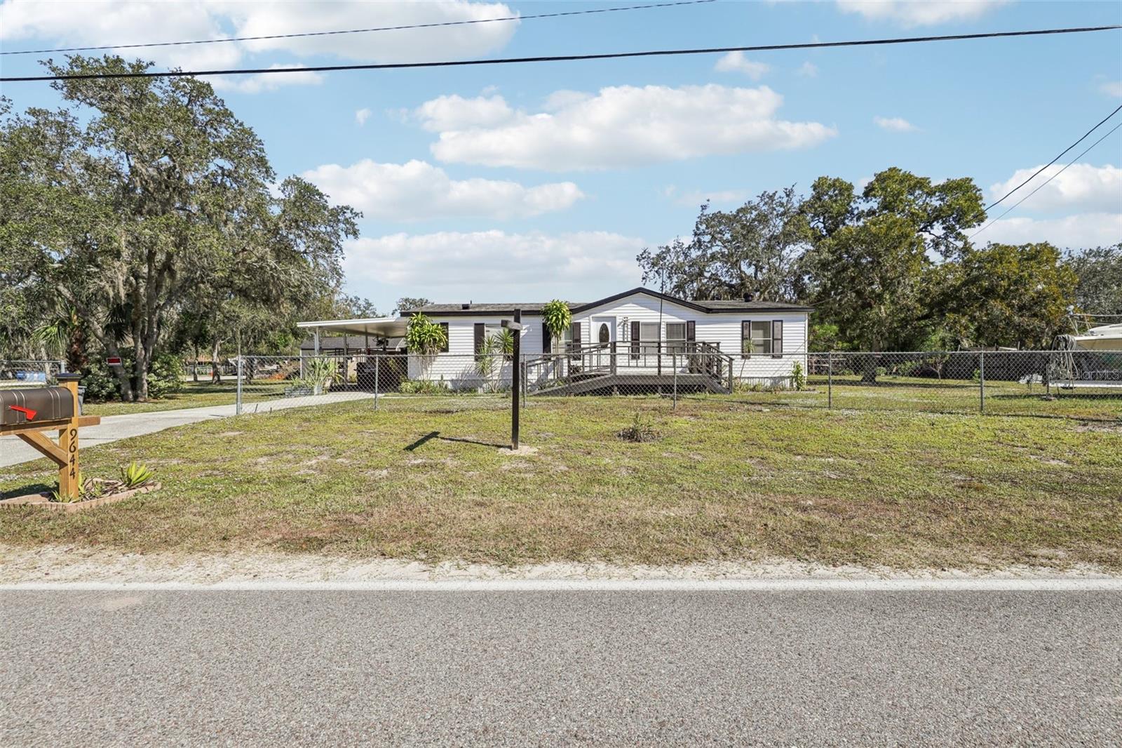 This 3-bedroom, 2-bath manufactured home built in 1998 sits on a nice big two-parcel  combination corner lot in the Moon Lake community of New Port Richey, offering over half an acre of total land with endless potential with a total of five lots (lots 17-22). The home features a mix of updates along with areas ready for your personal touch, giving you the flexibility to move in now or continue upgrading as you go. The open layout, spacious kitchen, and comfortable bedrooms make it easy to imagine your perfect setup. Out back, there’s a huge fenced yard with plenty of room for entertaining, gardening, storage, or future expansion. The second parcel adds tremendous value—it can be kept for extra space, resold, or even built on in the future (buyer to verify zoning and use). The seller is also offering a credit at closing to assist with any updates or repairs that may be needed to help ensure the home qualifies for insurance and financing. This is a rare opportunity to own two parcels for one great price in a growing area, offering space, privacy, and investment potential all in one.