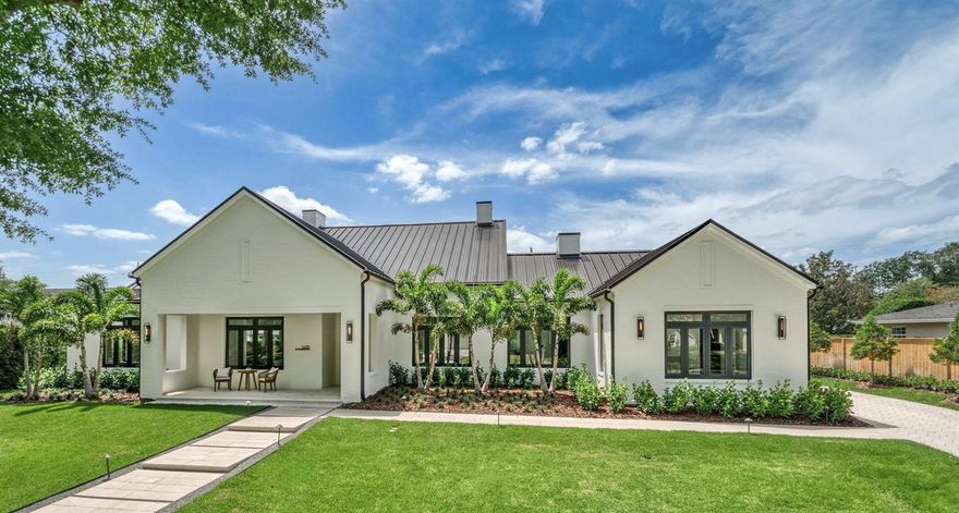 Introducing a Masterpiece of Modern Design, where sophistication meets everyday livability. With striking curb appeal, exceptional craftsmanship, and timeless design, this residence includes SINGLE-LEVEL LIVING, a thoughtfully designed CASITA and a spacious 3-CAR GARAGE—offering style, quality, and convenience at every turn. 
Step inside to discover timeless & stunning design elements, infused with inviting warm tones throughout. The awe-inspiring Great Room is a bold expression of architectural artistry with soaring 21’ vaulted ceilings clad in white oak tongue-and-groove with exposed beams, white oak plank floors, and clerestory windows that flood the space with natural light. A dramatic floor-to-ceiling brick feature wall hosts a sleek linear gas fireplace, while a series of pocketing glass doors seamlessly connects the indoors to the expansive veranda— for effortless indoor-outdoor living.  
The sophisticated kitchen is a culinary haven, featuring a minimalist aesthetic with sleek low-profile hand-crafted cabinetry that includes elegantly inset bar nook & a cleverly concealed walk-through pantry with a wine refrigerator. Adding to the undeniable allure is a striking 17’ island and a Thermador appliance package that includes 48” gas range & double ovens, integrated refrigerator & freezer columns, built-in coffee system, microwave drawer, two dishwashers & ice maker, that will impress even the most discerning chef. 
Flowing seamlessly from the Great Room, you’ll find a wonderful space—framed by striking exposed beams and dramatic statement lighting—that invites you to customize it around your lifestyle. Envision it as a refined dining room for unforgettable dinner parties, an intimate lounge for sipping rare bourbons and showcasing your wine collection, or a sophisticated home office where productivity meets inspiration.
A private vestibule leads to the owner’s suite, a serene sanctuary featuring vaulted ceilings with exposed beams, an expansive walk-in closet, and an elegant bath with meticulously refined décor that invites relaxation with a sleek modern vanity with minimalist hardware, & crisp quartz counters, free-standing soaking tub & frameless glass walk-in shower. 
Perfect for extended stays or multigenerational living, the guest room was specifically designed with everything generously proportioned including the over-sized walk-in closet and chic bath with elegant finishes. Nestled away, the third and fourth bedrooms are also spaciously designed and thoughtfully appointed—each featuring their own stylish bath and a custom walk-in closet. 
Step outside where the grand covered veranda elevates outdoor living with fully-equipped summer kitchen, brick accent wall, custom hood, motorized screens & artistic pavers overlook the stunning saltwater pool with double sun shelves, spa, and fire feature.
The thoughtfully designed casita offers a world of possibilities—as a guest retreat, home office, or even a creative studio. Complete with a sleek built-in kitchenette, a beautiful bath, and stunning views of the pool area, it’s a true extension of the home. 
Don’t miss this one-of-a-kind build on huge 125 x 135 lot in the esteemed tree-lined Beverly Shores/Rose Isle neighborhood, with convenient access to the charming shops and restaurants of the iconic Park Avenue in downtown Winter Park, as well as the vibrant events, farmers markets & restaurants in downtown Orlando.