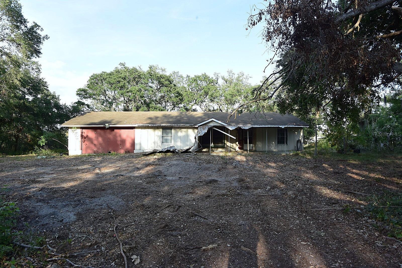 Discover 6.45 acres of opportunity on the scenic Alafia River! A recent survey reflects 4.48 acres of combined upland, providing plenty of usable land to create your dream riverfront retreat. The property includes a 1,236 sq ft wood-frame home with a 440 sq ft enclosed porch (with wall unit) and an oversized 505 sq ft two-car garage. The home does not appear to have been flooded from last year’s hurricanes. On Lot 4, there is a dilapidated singlewide mobile that will need to be removed, as it crosses the lot line and is in poor condition. Additional features include a large shed with an overhead garage door on Lot 4 for extra storage. With county review, there may be potential to obtain a variance for placement of a tiny home or small mobile. This main home on Lot 2 may also be eligible for renovation under the FEMA 50% rule, currently allowing up to $120,104 in improvements without requiring full compliance with floodplain management standards. Whether you envision a serene riverfront compound, a creative renovation project, or future development possibilities, the canvas is ready. With vision and effort, this property could become an incredible river oasis!