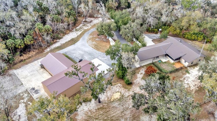 Experience space, strength, and self-sufficiency on 9+ private acres in this energy-efficient 3-bedroom, 2-bath home tucked away at the end of a cul-de-sac with two conjoined expansive shops. The workshops are 30x60 and 51x32 providing 3,500 square feet with multiple points of entrance including a 14ft high roll up door perfect for you RV or Boat storage. Designed for durability and performance, this well-built residence features R-40 insulated walls and an R-70 insulated metal roof, delivering exceptional year-round efficiency and comfort. The polystyrene concrete post-and-beam construction ensures long-term structural integrity and low maintenance.

A whole-property backup power system provides peace of mind with an Onan generator (45 kW three-phase / 30 kW single-phase) and 200-amp automatic transfer switch. The generator powers both the home and shops and includes a dedicated propane tank—ideal for uninterrupted living.

Interior and system upgrades include a new AC and heat pump, recently cleaned HVAC ducts with new registers and vents, and a gable attic fan to enhance ventilation and efficiency.

Water, Power & Utilities:
 • Connected to both city water and a private well (new well pump installed)
 • City and well water lines extended to the rear shop
 • Irrigation system supplied by well water
 • Gas line connected to tankless water heater and porch BBQ grill. 

With extensive workshop space, resilient construction, and premium utility infrastructure, this property offers a rare opportunity for those seeking privacy, functionality, and energy independence in Lakeland.

The expansive acreage creates endless opportunities for outdoor adventures. With room to roam and the tranquility of nature right outside your door, this property delivers the rare combination of seclusion and community. It’s more than just a home, it’s a private family haven designed for comfort, security, and lasting memories.