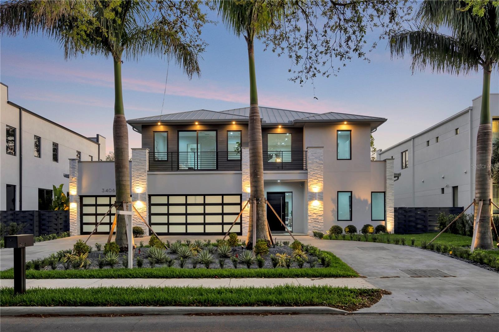 Welcome to this luxurious, Modern Architectural design in Palma Ceia, located in South Tampa! As you pull into the concrete finished circle driveway, you are welcomed with mature royal palms & landscape that is highlighted with spa stones. You will notice the brilliant contrast of colors and textures from white natural stacked stone, to bronzed aluminum garage doors & rails.
Upon entering you are greeted with an 8 ft riveted horizontal plank modern front door stimulating you with elegance. You walk into a 20ft foyer with an entire wall to your left beautifully designed in your modern day version of wainscoting. To the right you have a white oak-stained grey, floating staircase, supported with a heavy duty steel spine. Stairwell leads to an open second floor hallway, outlined with grey aluminum rails. Your water feature and garden, under the floating staircase, invites calm & relaxation to your productive day.
Next you have your wet bar adjacent to the wine storage leading to your open living, kitchen and dining area with large windows and open views of the pool|spa area.
The living area has a custom built console, under tv, on a porcelain tile accent wall. Kitchen includes top notch Kitchen Aid appliances along with your microwave & oven combination. Custom made, solid wood, kitchen cabinets provide plenty of storage; and beautifully blend white and brown, with grey natural stone for your counter tops. Walk-in pantry sits across the mudroom and leads into your 3-car garage.
The outdoor living area, ideal for entertaining, consists of a heated Salt Water Pool & Spa. Outdoor kitchen includes fridge, grill, hood, storage, and sink with stone counter tops. Your patio has plenty of space to eat and lounge. Leisure area on side of house can be used for a variety of purposes and entire backyard is landscaped for privacy & enclosed with a powder-coated, basket weave, aluminum fence.
Guest bedroom with en suite, and another room between powder bath located on first floor.
Second floor you have two master bedrooms, bonus room, guest bath and laundry room. Each Master bedroom has an outdoor patio and en suite bathroom with walk-in closets. Porcelain tile backsplash and natural stone counters design every restroom. Bonus room is ideal for using as an office, and provides plenty of natural lighting. This room has access to back patio.
Spacious laundry room contains large capacity washer and dryer, marble backsplash over the sink & counter, and a broom closet with storage. Room has enough space to add a table for folding clothes.
Extra special features include: Porcelain tile throughout, large impact windows, wood composite on wall over front balcony and on back patio ceiling, 5 sets of double doors, elegant chrome chandelier. All windows & garage-glass, Miami-Dade wind grade. This smart house is surrounded with a state of the art Surround System, lighting controls and surveillance. Walking distance to Bayshore! Located near Hyde Park, Riverwalk, Downtown, Hospital, Airport, Malls, Shopping and Restaurants! Plant High School District.