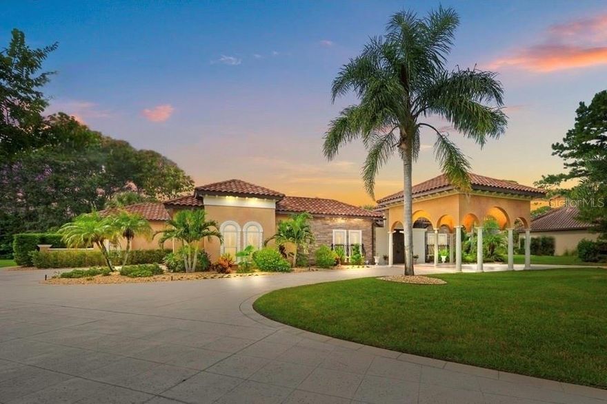 Along the serene waters of the Tomoka Preserve, stands a Mediterranean palazzo of rare distinction, created to be a piece of art in its own right. A scenic drive through the preserve, lined with majestic palms draped in Spanish moss, leads to this private waterfront estate offering a perfect balance of elegance and tranquility. Resting on 1.24acres of private lagoon front, this award-winning custom estate offers both prestige and seclusion. Blending elegance with nature, occasional deer may pause to watch you fish or canoe from the backyard. At the end of a quiet cul-de-sac, the home greets visitors with a regal canopy entrance, a sweeping-wide circular driveway, Venetian columns, Italian curved terracotta roof, paver-lined paths and tropical landscaping. A life-size “Signora dell’Acqua” fountain (lady of the water) and river rock gardens complete the essence of a Mediterranean retreat. Past the main gate, one will find a 2,294-sq.ft screened courtyard, complete w/  Venetian-style stone bridge across the travertine pool complex, featuring a waterfall, dipping pool, heated hot tub and a main saltwater heated pool with a swim-up bar, water curtain and controllable LED lighting. Outdoor dining is enhanced with hand-painted frescoed walls, a roofed kitchen & grill, an oversized fireplace anchors the lanai. Multiple covered seating areas, from coffee retreat by the spa to a central dining pavilion. Inside, soaring ceilings, some rising up to 16ft, hand-plastered walls, Italian-style frescos, and grand crystal chandeliers set the tone. The Grand Room offers panoramic views of the river and courtyard; The chamber of custom display cabinetry is complemented by wine and coffee bar, complete with cast-iron French doors and frescos of the Italian countryside. Pocketing glass doors dissolve boundaries between indoors & out, inviting breezes from the lagoon. The kitchen combines elegance with function: Monogram appliances, a 6-burner stove w/ griddle, double ovens, dual Fisher & Paykel dishwashers, floor-to-ceiling custom cabinetry, a granite island, a spacious walk-in pantry, serving stations, and abundant storage. The master suite is a private sanctuary with oversized windows and direct access to the outdoor spa. Hand-painted frescoed hallway leads to dual vanities & expansive stone double shower. Two oversized walk-in closets offer crystal chandeliers and solid wood shelving. Additional bedrooms include a in-law suite w/ a private courtyard entry, a junior suite with French doors and a flexible media lounge/ bedroom w/ veranda access. Beyond the bedrooms, the estate surprises at every turn. A walnut-clad office conceals a secret “Hide-Away Room,” while the Relaxation Room features a fireplace & river views. Card Room opens to the dining space. Even the foyer impresses with a cast-iron French glass door and chandelier. While steeped in romance, the home is built for peace of mind. Some of the recent updates include a 6-zone irrigation system with new well, pump, Wi-Fi controls, termite protection, upgraded pool/ spa mechanics & heaters. The new water filtration system provides exceptional water quality. This estate also offers a whole-house vacuum system, 32-camera monitoring, invisible dog fence, hurricane shutters, a hidden safety room, a climate-controlled garage & a whole-house generator. Truly a rare offering: being one of two estates with direct lagoon access to the Halifax River. This Venetian Palazzo is more than a home- it’s a statement.