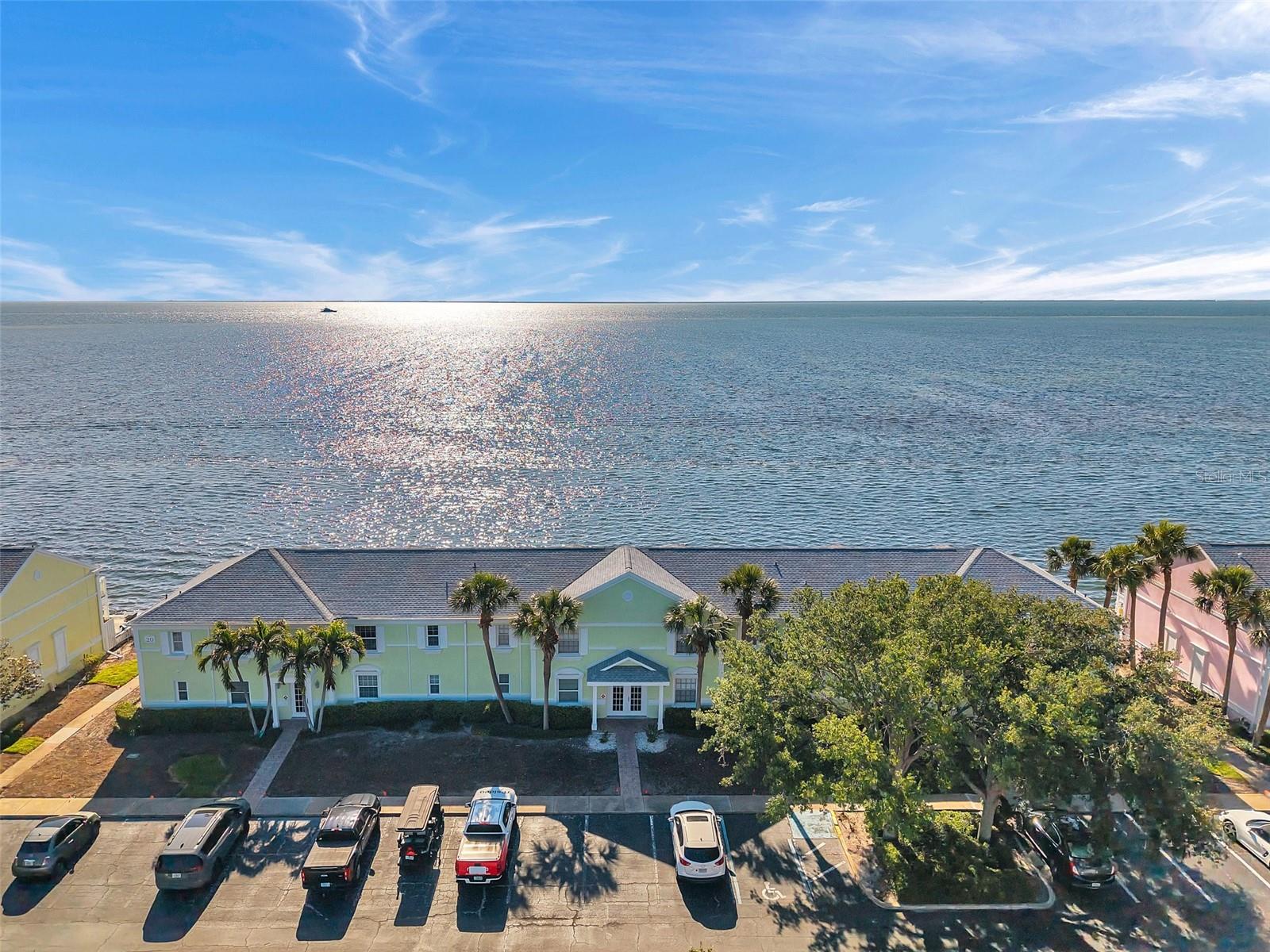 Wake up to breathtaking sunrises over the water in this directly waterfront, beautifully updated, and fully furnished 1-bedroom, 1-bath condo—ideally located in the desirable, 24/7 gated community of Waterside South. Just steps from the waterfront pool and yacht club, this turnkey home is perfect for vacation use, rental income, or year-round enjoyment. Inside, you’ll find stylish upgrades—accent wallpaper, premium flooring, and a modern bathroom with a sleek frameless glass shower door. The renovated kitchen features new appliances and hurricane-impact windows (2023), while a cozy electric fireplace adds warmth and charm to the spacious living area, new HVAC (2022) and new water heater (2025). Additional conveniences include an in-unit washer and dryer and direct bathroom access from the main living space. Waterside South spans 88 waterfront acres and offers unmatched amenities: two resort-style pools (including one waterfront), a fitness center, multiple tennis and pickleball courts, kayak storage and launch areas, a sand volleyball court, and available boat slips for rent or sale. Recent improvements include a new roof (less than two years old) and upgraded balcony decking. Best of all, no flood insurance is required, and the HOA covers nearly everything—water, sewer, cable, and internet—making this a true lock-and-leave lifestyle. Just close the door and go, whether you're heading out for a weekend or an extended trip. Whether you're looking for a serene retreat, a rental-ready investment, or a carefree waterfront lifestyle, this move-in-ready condo checks every box. Don’t miss this opportunity—schedule your private showing today