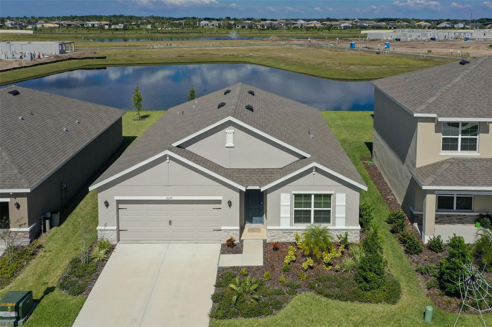 SELLER GIVING UP TO $10,000 TOWARD A 2/1 RATE BUYDOWN FOR BUYER on this WATERFRONT HOME that has private backyard with no neighbors and no busy road behind you. If you are wanting the perfect blend of conveniences such as library, aquatic centers, sports centers, schools and shopping at your fingertips yet peace, quiet and serenity, then this is the home for you! It is BEAUTIFULLY MAINTAINED in like new condition and tucked into the community for peace and quiet! Imagine sitting on your back patio enjoying a beautiful WATER VIEW and just the occasional sounds of nature for a relaxing morning or evening. Peaceful enough to read a book or just sit enjoying a cup of coffee. This is a one owner home and has been maintained in PRISTINE, NEW CONDITION! BARELY LIVED IN and only FOUR YEARS OLD. This home is also under remainder of builder structural warranty. This SINGLE STORY home has tile flooring through most of the home, STAINLESS STEEL APPLIANCES and beautiful GRANITE COUNTERTOPS! Most of the home enjoys the WATER VIEWS! This home sits on an oversized, level home site large enough to add your own pool and cabana if you desire! Located less than a block away from the tot lot and two blocks away from the community amenities center with the community pool. The backyard is facing northwest which makes for a very comfortable lanai area and ability to catch the beautiful Florida Sunsets across the water! Located just a few steps from the PREMIER SPORTS CAMPUS and the NEW LAKEWOOD RANCH ATHLETIC/AQUATIC CENTER with pool, gym and so much more, opening 2026! A few steps from the new LAKEWOOD RANCH LIBRARY, the new Publix coming and so much more at your fingertips in this amazing location! Also NEW LAKEWOOD RANCH HIGH SHCOOL opening on Aquatics Center campus opening August 2027. NEW K-8 SCHOOL OPENING AUGUST 2025! NEW MIDDLE SCHOOL OPENING AUGUST 2026! Conveniently located to Lake Manatee State Park with easy access to I-75 and new shopping centers, grocery stores and restaurants, this is a PRIME LOCATION for all conveniences. This home is the perfect blend of convenience in every way yet serenity as well! Come see this beautiful on a peaceful home site in a spectacular neighborhood!