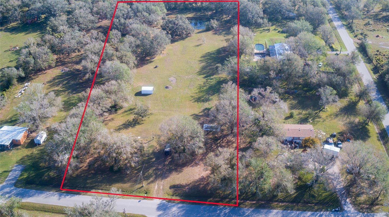 Charming 2.8-Acre Property with Stocked Pond and Stunning Oak Trees, Discover your perfect slice of paradise with this picturesque property! Nestled in a serene and high-and-dry location, this gem boasts a host of impressive features, beautifully maintained acres offering ample space for your vision. Ready for you to build your dream home or enjoy as a tranquil retreat. There is existing power, a well with a new pump, and a septic system in place for your convenience. Gorgeous, mature oak trees provide a lovely canopy and add to the property’s charm awaits you, complete with a brand-new dock for relaxing or fishing. The property is fenced on three sides, ensuring privacy and security. A recent survey has been completed, providing clear boundaries and ease of development.
This property combines natural beauty with practical amenities, all set in a desirable location. Whether you're looking to create a private retreat or a new homestead, this land offers a wonderful opportunity