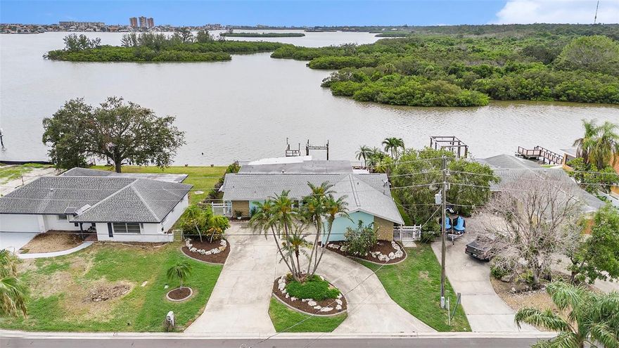 NEW PRICE – WATERFRONT VALUE OPPORTUNITY IN OAKHURST SHORES!
 Step through the front door & your eyes are immediately drawn across the open living space to WIDE OPEN WATER VIEWS that feel more like a PRIVATE RETREAT than a typical neighborhood home. Now offered at $1,049,000 — approximately $130,000 BELOW recent Appraised value — this property presents a rare chance to own a true waterfront lifestyle home with IMMEDIATE EQUITY! Positioned on approx 70 feet of seawall along quiet inland water, the property offers the perfect balance of boating access & peaceful surroundings. Enjoy low boat traffic, no rear neighbors, frequent DOLPHIN & MANATEE sightings, and year-round SUNSETS from YOUR BACKYARD thanks to the desirable NW exposure. The location also delivers a spectacular bonus — multiple fireworks displays visible from your backyard on holidays like the Fourth of July & New Year’s Eve.
Outdoor living is exceptional with a composite dock, wrapped piers, and boat lift, making this a dream setup for boating enthusiasts or anyone who appreciates life on the water. The expansive covered patio & fenced yard create an ideal space for relaxing, entertaining, or simply enjoying the view.
Inside, the nearly 2,000 heated square feet offers a flexible layout with water views from nearly every room. The home also features a straightforward 3rd bedroom conversion within the existing footprint (see floor plan with dotted lines). A written contractor estimate places the cost at approximately $20,000, allowing a buyer to quickly transform the home into a 3-bedroom waterfront property while still remaining well below appraised value.
The property is located in unincorporated Pinellas County where short-term rentals are permitted, opening the door to additional income potential for buyers seeking an investment or vacation rental opportunity.
The home was professionally remediated and rebuilt by a licensed contractor following minimal water intrusion in 2024, with all permits closed and finalized for complete peace of mind.
Major updates include:  • Brand new April 2025 4-ton 14.3 SEER AC system with 10-year parts warranty  • Updated electrical panel  • Double-pane windows and PGT sliding glass doors
 • Roof replaced in 2017  • Ceramic plank flooring throughout  • Updated primary & guest bathrooms
The kitchen offers expansive quartz countertops, abundant shaker cabinetry, Whirlpool appliances, built-in microwave/oven with air fryer, beverage fridge, & two breakfast bars, creating an ideal space for everyday living and entertaining.
Both bedrooms feature private en-suite baths, while the spacious primary suite includes 2 oversized walk-in closets, dual vanities, & a large walk-in shower with dual rain heads.  Flood insurance is approximately $3,400 per year and is transferable.
Located less than 10 minutes to Gulf beaches, parks, shopping, and Bay Pines VA, and approximately 40 minutes to Tampa International Airport, this property offers the perfect combination of waterfront lifestyle, long-term value, and future potential.