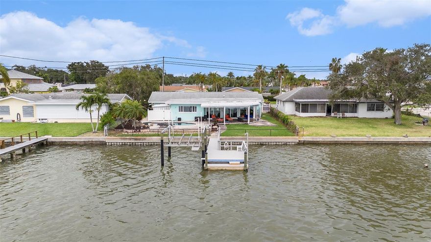 NOW PRICED $100,000 BELOW RECENT APPRAISED VALUE — THIS IS THE VALUE OPPORTUNITY IN OAKHURST SHORES. Offered at $1,080,000, this Inland waterfront property delivers breathtaking views, extensive Updates, & the rare advantage of BUILT-IN EQUITY POTENTIAL. With nearly 2,000 HEATED SQUARE FEET and a flexible layout, the home offers a STRAIGHTFORWARD 3RD BEDROOM CONVERSION within the existing footprint — written estimate less than $20,000 - see floorplan dotted lines— allowing a buyer to immediately enhance both function and future resale value.
Experience WATER VIEWS FROM PRACTICALLY EVERY Room & provides a Real connection to Nature! Enjoy LOW & QUIET BOAT TRAFFIC, NO REAR NEIGHBORS, and frequent visits from DOLPHINS & MANATEES — creating a peaceful, private backyard setting that feels like a daily retreat and the SUNSETS are amazing year-round. Flood insurance is approximately $3,000 PER YEAR and is TRANSFERABLE.
Outdoor features include a COMPOSITE DOCK, WRAPPED PIERS, BOAT LIFT, FENCED YARD, and an EXPANSIVE COVERED PATIO ideal for entertaining or relaxing waterside. Inside, the home was PROFESSIONALLY REMEDIATED & REBUILT BY A LICENSED CONTRACTOR following minimal water intrusion in 2024, with ALL PERMITS CLOSED & FINALIZED for complete peace of mind.
Major updates include a BRAND-NEW APRIL 2025 4-TON 14.3 SEER AC SYSTEM with 10-YEAR PARTS WARRANTY, UPDATED ELECTRICAL PANEL, DOUBLE-PANE WINDOWS, PGT SLIDING GLASS DOORS, ROOF REPLACED IN 2017, CERAMIC PLANK FLOORING, and UPDATED PRIMARY & GUEST BATHS — making this home TRULY MOVE-IN READY.

The kitchen offers MASSIVE QUARTZ COUNTER SPACE, ABUNDANT SHAKER CABINETRY, WHIRLPOOL APPLIANCES, BUILT-IN MICROWAVE/OVEN WITH AIR-FRYER, BEVERAGE FRIDGE, and TWO BREAKFAST BARS. Both bedrooms feature PRIVATE EN-SUITE BATHS, while the PRIMARY SUITE includes TWO OVERSIZED WALK-IN CLOSETS, DUAL VANITIES, and a LARGE WALK-IN SHOWER WITH DUAL RAIN HEADS.  
Located LESS THAN 10 MINUTES TO BEACHES, SHOPPING, PARKS, AND BAY PINES VA, and approximately 40 MINUTES TO TAMPA INTERNATIONAL AIRPORT, this property delivers LOCATION, LIFESTYLE, AND LONG-TERM VALUE.