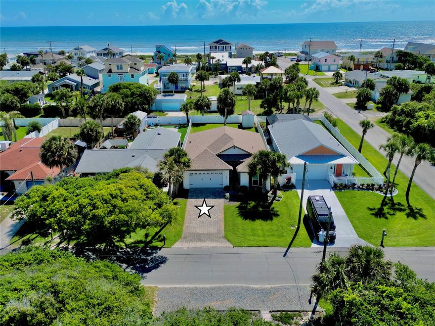 Built in 2020 and ideally located just two blocks from the ocean, this move-in ready custom 3-bedroom, 2-bath home sits on a high-and-dry lot in golf cart-friendly Flagler Beach. Enjoy a short walk to the beach along with easy access to the coastal lifestyle this area is known for.

Inside, you’ll find 10-foot ceilings, 8-foot interior doors, 6-inch baseboards, LVP flooring, tile baths, impact windows, plantation shutters, and soundproofing in the interior walls for added comfort. The beautifully designed kitchen features double-stacked cabinetry with glass uppers and lighting, granite countertops with waterfall edges, marble backsplash, propane range, convection microwave, beverage refrigerator, upgraded fixtures, and generous pantry storage with upgraded wood shelving.

The primary suite offers custom California closets, while the second bedroom includes a Murphy Bed and desk with a 25" x 80" work surface, creating the perfect flexible guest room or home office. Additional features include a whole-house on-demand generator, on-demand water heater, indoor laundry room with utility sink and Samsung washer/dryer, pull-down attic stairs with partially floored attic space, epoxy garage flooring, and an 8' garage door.

Outside, enjoy a paver driveway, full vinyl-fenced backyard with 10' gate and alley access, irrigation on a well, gutters, soffit lighting, outdoor shower with hot and cold water, 8' leaded impact front door, and an 8' x 12' storage shed with electric service. Relax on the covered patio and enjoy morning sunrises. With quality construction, coastal convenience, and a prime beachside location, this Flagler Beach home is truly a must-see.