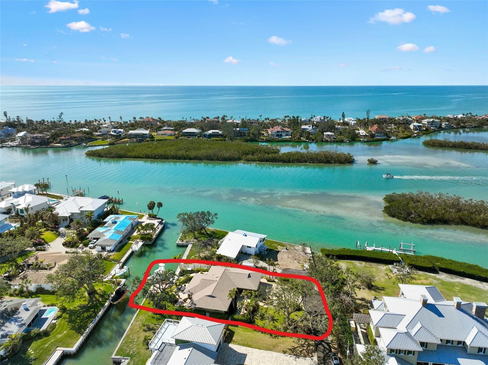 Well-built home that sits high and dry yet close to the Jetties and Open Water! No flooding or hurricane damage. Perfectly nestled between the culturally rich Sarasota and the quaint charm of Venice, this home is your gateway to the Nokomis, Siesta Key, and Venice beaches. Here, life unfolds in a symphony of sun, sand, and sea! The No. 1 rated Pine View School is nearby. Indeed, you may indulge in every hobby you can dream of. Traverse the Legacy Biking Trail, unwind with a round of trap, skeet or sporting clays at Knights Trail Park, or get your equine fix at Fox Lea Farm. Dine and shop by golf cart along the waterfront, and embrace the home’s signature activities: sunset gazing, boating, and fishing. Step out to your boat in the back yard and be on the Gulf of America in minutes. For those who crave an unmatched waterfront existence, there's simply no comparison. This modern abode perches regally on a lot crafted for outdoor enjoyment, with professional landscaping, and terraced paver areas that invite you to bask in the glory of Florida Gulf Coast sunsets. Elegant landscape lighting casts a glow on the three mature oak trees, showcasing the home's natural allure. Step into a chef's kitchen that's a culinary dreamland, boasting a Wolf gourmet range, a Sub-Zero refrigerator-freezer, and a Bosch dishwasher. Custom-built, solid cherry cabinets with soft-close features and a walk-in butler’s pantry provide endless storage. The heart of this home is the 12-foot granite island, complete with an eat-in bar, overlooking two chef-curated vegetable and herb gardens and the soothing intracoastal waters. Large windows and sliders bathe the space in natural light, blurring the lines between indoors and out. A true split floor plan keeps the master en-suite distinct from two additional bedrooms, each boasting custom-built walk-in closets. The oversized garage, freshly coated in epoxy, is a dream for organization and storage, ideally suited for your fishing and boating gear. The dock stands ready for your catch of the day, equipped with a custom fillet table, fresh water, dock box storage, and dockside power. Don't miss your chance to experience this truly exceptional home!