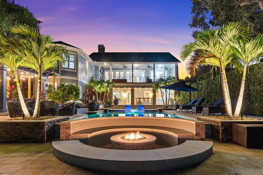 Inspired Waterfront Living on Lake Tarpon Discover this stunning 7,682 SF estate which includes a full guest apartment on nearly one acre offering breathtaking views of the 2,500-acre Lake Tarpon. Gated for privacy, it features a private dock with 10,000-lb boat lift for sunset cruises, fishing, or kayaking, all with no HOA fees or flood insurance required. Nestled in the prestigious Palm Harbor University school zone, this move-in-ready haven combines serene lakefront allure with sophisticated luxury for discerning buyers. Over $400K invested in a "backyard nirvana" by acclaimed designer Ryan Hughes creates an unparalleled outdoor oasis: resort-style pool with ledge loungers, glistening tiled infinity-edge spa, sunken fire lounge, charming pergola, cozy moon daybed for stargazing, and dramatic custom lighting blending light, water, and fire across travertine decking amid stately grandfather oaks and vibrant tropical landscaping. The extensive covered lanai seamlessly connects to indoor spaces, ideal for gatherings, while the open floor plan greets with immediate lake views through walls of glass in the expansive family room, accented by a fireplace and decorative tray ceiling.
Inside, the chef's kitchen shines with quartzite island and granite countertops, custom cabinetry, Wolf commercial gas range, SubZero appliances, double ovens, walk-in pantry, and casual dining. The main-level owner's retreat boasts a beamed vaulted ceiling, serene lake views, dual closets, and spa bath with jetted tub and shower. Lower-level entertainment includes a bonus room with full wet bar, home theater, home gym, extra storage, three bedrooms, two baths, new tile, 2nd laundry room and lots of storage—plus a separate in-law suite with full kitchen, living/dining, and laundry. Recent updates feature a brand-new roof (2025), five AC units replaced since 2019, 3 tankless water heaters, whole-home water softener/filtration, fresh paint, extended driveway, Generator, dedicated podcast room, and tech-savvy amenities like WiFi 6, Sonos audio, Mohen AI leak detection, integrated security, and smart locks. Accessed via gated cobblestone entry to a spacious motor court and Trex-decked porch, this unmatched property redefines waterfront sophistication.