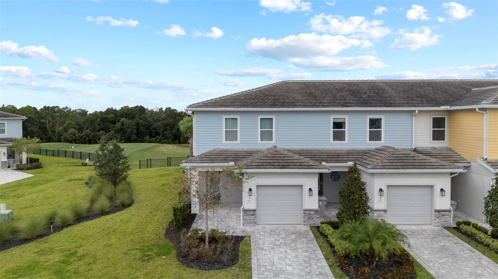 Welcome to your dream townhome in the heart of Reunion Resort! This beautifully designed 3-bedroom, 2.5-bathroom end-unit offers the perfect blend of luxury, comfort, and convenience. Whether you’re looking for a full-time residence, second home, or investment property, this townhome checks all the boxes. Step inside and be greeted by soaring 10-foot ceilings, an open-concept floor plan, and an abundance of natural light. The kitchen boasts quartz countertops, stainless steel appliances, a gas range, and ample space for entertaining, all overlooking the dining and living areas. Ceramic tile flooring runs throughout the first floor, and a convenient half bath sits at the base of the staircase for guests. Upstairs, you’ll find two spacious bedrooms at the front of the home with a shared full bath, plus a laundry closet in the hallway. The primary suite is tucked away at the back of the home, surrounded by windows with breathtaking views of the Jack Nicklaus golf course. The en-suite features dual sinks, a walk-in shower, and a large walk-in closet. The entire second floor is upgraded with luxury vinyl plank flooring. Outside, unwind on your private patio with unobstructed views of the driving range and unforgettable Florida sunsets. A brick paver driveway, attached 1-car garage, and private lanai entry complete the exterior. This home comes fully furnished with modern décor and includes an active, transferrable Reunion Resort membership, giving you access to the following world-class amenities: Three PRIVATE PGA Golf Courses designed (Jack Nicklaus, Tom Watson, and Arnold Palmer), 10-acre water park & lazy river, 8 swimming pools, Tennis & pickleball courts, footgolf, fitness centers, playgrounds & miniature golf, on-site dining, including the rooftop restaurant Eleven with panoramic views of Orlando and the Disney fireworks, theme park shuttle service and more! All of this just 15 minutes from Walt Disney World, 20 minutes from Universal Studios, and 30 minutes from Orlando International Airport. Don’t miss your chance to own this luxury corner townhome with one of the best views in Reunion. Schedule your private showing today!