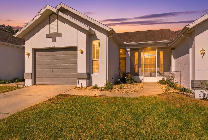 One or more photo(s) has been virtually staged. Welcome to this well maintained, single-story home in the desirable Royal Oaks Community in Inverness. Positioned on a lot with a neat lawn and irrigation system, you’ll be greeted by a paved driveway leading to the garage and a covered front entry with screened porch that brings in bright natural light. Inside you’ll find a smooth flow of luxury vinyl flooring in the main living areas. The kitchen offers generous cabinetry and counter space and opens to the dining area framed by windows that fill the space with daylight. The family room creates a comfortable central gathering spot with large glass doors and windows that connect to the sunroom for easy indoor-outdoor living. The primary bedroom is a peaceful retreat with a walk-in closet and bathroom with an accessible shower. The second bedroom also features a walk-in closet and sits near the full secondary bathroom with tub-shower combo and additional storage. The sunroom extends your living space with big windows and a finished floor, perfect for relaxing or enjoying views of the backyard. Laundry space is conveniently located in the garage. Royal Oaks offers a range of community amenities that enhance everyday living. The HOA covers grounds maintenance and community upkeep, and residents enjoy access to a community pool and recreation facilities as part of the association services. Utilities such as water, sewage, cable and internet are included in the HOA offering along with trash service and common area care. This means less upkeep for you and more time to enjoy the lifestyle this neighborhood offers. Living here puts you close to downtown Inverness with shopping, dining and local events, plus parks, lakes and outdoor trails like the Withlacoochee State Trail for biking and nature walks.