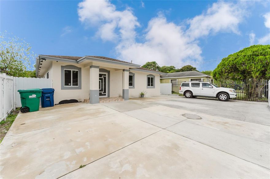 Built in 2017 and purchased directly from the builder, this one-owner luxury residence is a rare find in a market dominated by outdated flips. Offering 4 bedrooms, 2 baths, plus a private income-producing efficiency, this home combines modern design, solid construction, and smart investment value—having tripled in equity since purchase. The renovated kitchen features quartz countertops, an oversized island, tall shaker cabinetry with crown molding, stainless steel appliances, and an exterior-vented range hood, while the main bathroom was fully updated in 2025 and the home includes a dedicated interior laundry room. Major systems are already taken care of with a high-efficiency AC, tankless water heater, copper electrical wiring, a newer roof with full gutters, and a brand-new septic drain field serviced in late 2025. Full impact windows and doors throughout provide peace of mind and lower insurance costs. Outdoors, enjoy a fully permitted covered terrace with lighting, a large fenced lot with ample green space, and parking for 5+ vehicles. The rented efficiency helps offset the mortgage, making this an exceptional opportunity to live in modern luxury while generating income. Perfectly located just minutes from Brickell, Downtown Miami, I-95, and Fort Lauderdale Airport, this is more than a home—it’s a wealth-building asset.