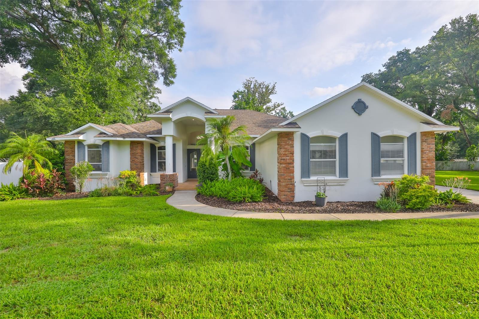 Welcome to this stunning Chadwell-built home located in the highly sought-after Valrico Forest community. This spacious 4-bedroom, 3-bathroom home with a dedicated den sits on a generous lot in a quiet, wooded cul-de-sac—just minutes from excellent schools. The inviting brick-accented exterior adds classic curb appeal. Inside, a grand foyer leads into the formal living room featuring triple sliding glass doors that open to the screened lanai. The formal dining room boasts rich wood flooring and elegant crown molding, ideal for entertaining. The open-concept kitchen and family room are perfect for everyday living, offering granite countertops, 42-inch cabinets with crown molding, a large breakfast nook, built-in shelving, and a wood-burning fireplace with a charming brick surround. The primary suite is a peaceful retreat with lanai access and custom built-ins. Attached is a versatile bonus room, ideal for a home office, nursery, or a 2nd walk-in closet. The en-suite bath features dual sinks, a jetted tub, walk-in shower, and walk-in closet.The split bedroom floor plan ensures privacy for the secondary bedrooms, located on the opposite side of the home. Step outside to a screened-in pool with an energy-efficient pump, raised garden beds, and a cozy firepit area—perfect for relaxing or entertaining. Additional highlights include: Fruit trees-Mango, Papaya, and Avocado. Updates include: Tankless gas water heater (2023), HVAC system (2023), luxury vinyl plank flooring in main living areas and bedrooms (2022), roof (2017), re-screened pool cage (2023), refrigerator (2024), and dishwasher (2025) Trees trimmed (2025) The enclosed third garage bay offers flexibility as a home office, gym, or additional storage. Ample closet and attic space throughout complete this well-maintained and move-in-ready home.