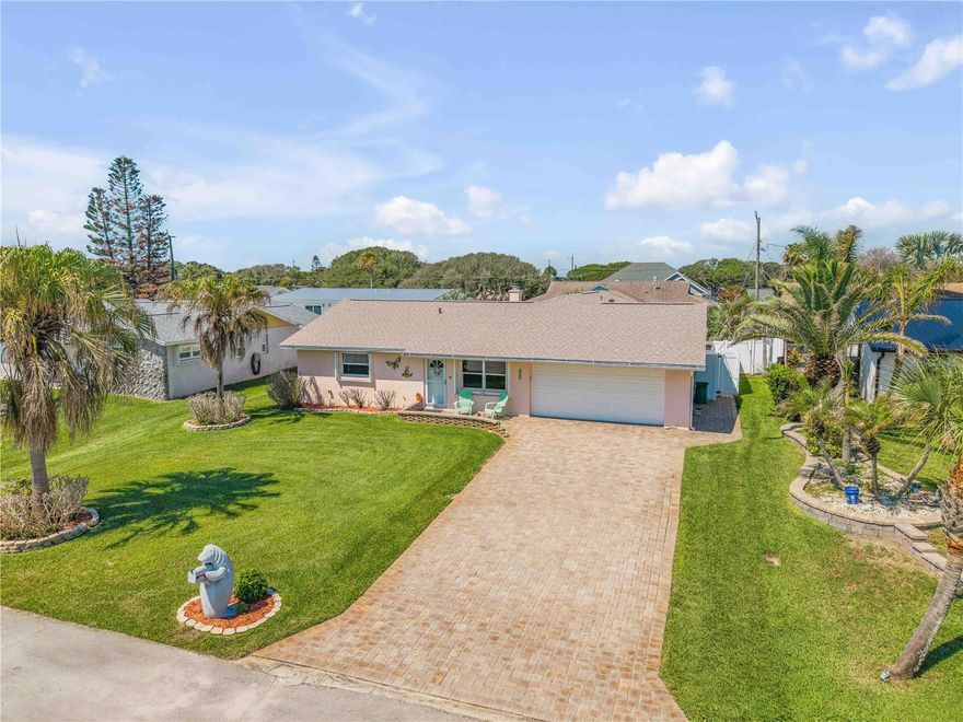 MUST SEE!! Welcome to 4440 Katy Drive, your beachside retreat in the heart of New Smyrna Beach. Ideally located just across the street from the sand and surf of the Atlantic Ocean and only a short drive to Flagler Avenue and downtown NSB’s shopping, dining, and entertainment, this adorable and immaculately maintained home showcases exceptional curb appeal and true pride of ownership throughout. This inviting 3-bedroom, 2-bath split-plan home features bright and comfortable living spaces designed for both everyday living and entertaining. Thoughtful updates can be found throughout, including beautiful wood-look vinyl plank flooring, a brand-new roof installed in 2026, remodeled guest bathrooms completed in 2025, a Rheem A/C system installed in 2024, and hurricane shutters for added peace of mind. The well-appointed kitchen is both functional and stylish, featuring granite countertops, stainless steel appliances, ample cabinetry, and generous storage space. The spacious living area serves as the heart of the home, highlighted by a cozy wood-burning fireplace with striking coquina stone accents and a custom cedar mantel that adds warmth and character. Outdoor living is equally impressive with a fenced backyard, oversized double-wide paver driveway, extra-deep two-car garage, outdoor patio area, and a convenient outdoor shower with direct access to an additional half bath located in the garage—perfect after enjoying a day at the beach. From the moment you arrive, this charming beachside home offers the perfect blend of comfort, functionality, and coastal lifestyle, all within close proximity to shopping, dining, entertainment, and breathtaking Atlantic Ocean sunrises.