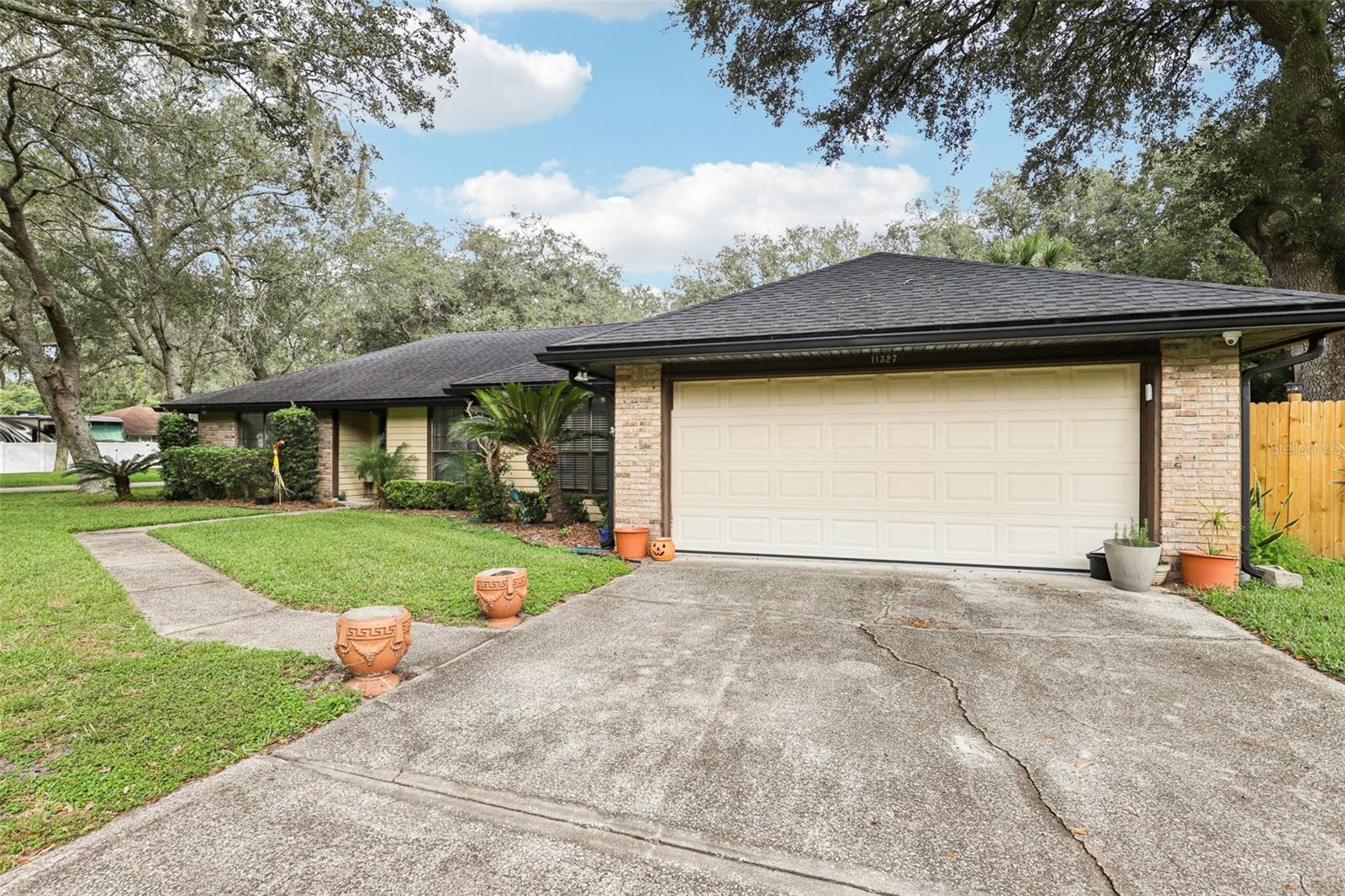 Tucked away on a quiet street this beautiful BRICK accented home perfectly situated on a CORNER LOT is ready for you to call HOME! Great neighborhood with NO HOA & a public park (1/4 mi) just down the street. You will be welcomed by tile floors throughout the main areas including a flex space (perfect for an office, play area, or sitting room), formal dining & living room complete with fireplace. Well-appointed kitchen with GRANITE counters & stainless-steel appliances. Wait until you see the SUNROOM an additional 240 sq ft of natural light (NEW window AC unit to be installed prior to closing) creating the perfect space to enjoy your morning coffee or read a book while the pups or kids play in your FENCED yard. Video security system installed, just needs to be hooked up for monitoring. Convenient location 8 mi to NS Mayport & St Johns Town Center, 10 mi to the Beach & 1 mi to Ed Austin Park. Tenant is moving out at the beginning of Nov 2025. Roof 2019. This is a must see!