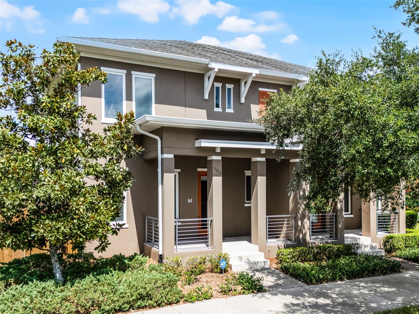 FAIRLY NEW TOWNHOME with Oversized Fenced Yard in the Heart of Laureate Park! Welcome to maintenance-free living in this beautifully upgraded 3-bedroom, 2.5-bath townhome featuring a rear-loading 2-car garage and 1,856 sq. ft. of thoughtfully designed space. From the moment you arrive, you'll fall in love with the inviting curb appeal and charming covered front porch—perfect for relaxing with your morning coffee. Step inside to an open-concept floor plan with a spacious living room, dining area, and kitchen, all enhanced by bamboo and ceramic tile flooring. The gourmet kitchen is as functional as it is stylish, boasting Quartz countertops, upgraded wood cabinetry with crown molding, stainless steel appliances including a microwave and dishwasher, and a large center island with seating. Sliding glass doors lead to a screened sunroom with a built-in dog door, ideal for pet lovers. Upstairs, you'll find handcrafted hickory-engineered wood floors and a spacious loft, perfect for a home office or bonus room. The primary suite features a large walk-in closet, and an elegant ensuite bath complete with dual sinks, a linen closet, and a brand-new spa-style shower with textured 12" slate walls, glass doors, non-slip flooring, and oil-rubbed bronze fixtures. Two additional bedrooms share a full bathroom, and a convenient laundry room includes a washer and dryer. The oversized fenced yard offers plenty of outdoor space for pets or entertaining, with a 4’ gate at the front and 8’ double gate by the driveway. Additional upgrades include HVAC with HALO air purifier, Epoxy garage floors, French drains and gutters, TESLA Charger, Smart security system, Updated smoke alarms, doorbell, and ceiling fans, Custom window curtains throughout. Laureate Park offers exceptional community amenities including a resort-style pool, splash pad, fitness center, walking trails, playgrounds, dog parks, and community events. Ideally located just minutes from Medical City, VA Hospital, Nemours, USTA, Boxi Park, and major highways (417, 528), with top-rated schools and Orlando International Airport just a short drive away. This home is move-in ready and priced to sell! A one-year home warranty is available upon request. Schedule your private showing today and experience the best of Florida living in Laureate Park!