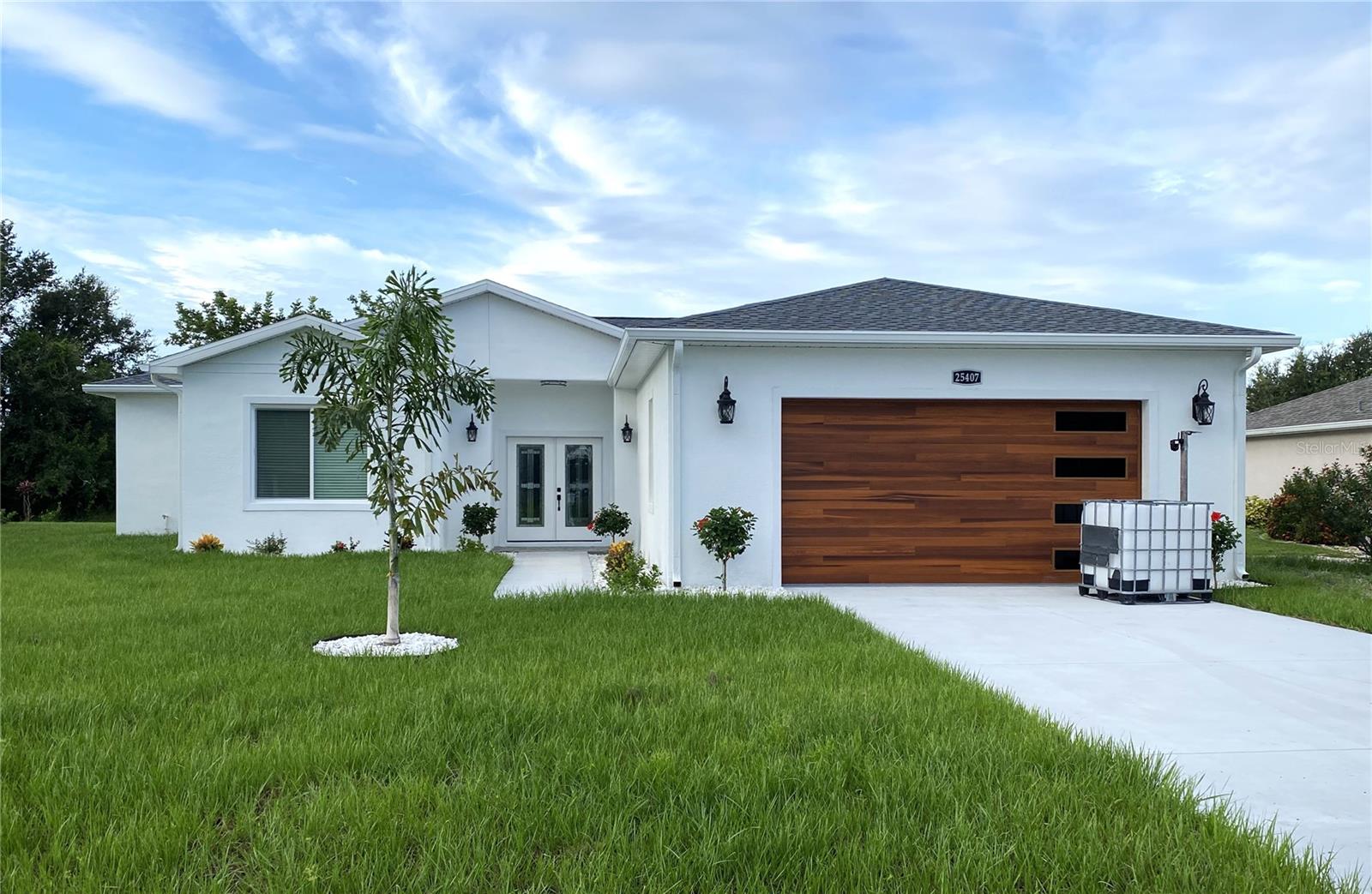 Why wait for a home to be built? This beautiful 3 bed, 2 bath beauty is ready for new owners! This thoughtfully designed residence on a cul-de-sac street offers 2,019sqft of living space with a well-planned split-bedroom layout combining comfort and style. The exterior impresses with a stunning garage door, lovely landscaping, and a covered front porch that welcomes you inside. Step into a spacious foyer where the home’s open floor plan flows effortlessly. Beautiful beadboard accents the family room ceiling & the kitchen island, making this a one of a kind property. Inside, luxury vinyl flooring extends through the entire home. The spectacular kitchen serves as the heart of the home, featuring quartz countertops, marble tile backsplash, built-in oven & microwave, a large walk-in pantry, a center island AND a wine refrigerator & cabinet!! The private primary suite at the back of the home includes a MASSIVE 15 x14 walk-in closet!!!, dual sinks, a beautifully tiled soaking tub, and a separate marble tiled oversize stall shower.....a truly luxurious retreat. Two additional bedrooms and guest bath provide flexible options for family, guests, or a home office. Windows and doors are Hurricane Impact glass, 50gal hot water tank, and an oversized 22x24 2-car garage with shining epoxy floors and plenty of extra storage space. The 10 x 17 under truss lanai is the perfect space for morning coffee or evening cocktails, and there's PLENTY of room for a pool. Check out this uniquely special home at once!