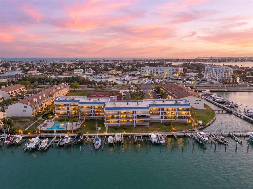 Welcome to waterfront luxury living at Anchor Cove, one of Tierra Verde’s most sought-after communities. This beautifully remodeled 2-bedroom, 2-bath one level residence has been transformed top to bottom with a sophisticated modern design and offers breathtaking open water views of Tampa Bay. The single-level open floor plan is filled with natural light and enhanced by hurricane-impact windows and doors, creating a seamless connection to the stunning waterfront backdrop. The living and dining areas flow effortlessly to a spacious private terrace overlooking the bay, ideal for morning coffee, sunset cocktails, and year-round outdoor enjoyment.  The spacious primary suite is ideally positioned on the water side of the home, offering peaceful bay views, a true retreat-like feel, and direct access to the terrace for effortless indoor-outdoor living.  Anchor Cove is a well-built, amenity-rich waterfront community featuring a large bayside pool and spa, two tennis courts, elevator access, covered tandem parking for two vehicles, additional storage, ample guest parking, pet-friendly and 30 day minimum rental policy.  Ideally located in the heart of Tierra Verde, residents enjoy quick access to Fort De Soto Park, St. Pete Beach, Pass-a-Grille, I-275, vibrant downtown St. Petersburg, nearby airports, waterfront dining, live music, marinas, and local boat clubs. The Residence Inn by Marriott directly across the street offers exceptional convenience for visiting guests while Vista at the Top, the hotel’s rooftop restaurant and lounge, creates the perfect setting to enjoy cocktails, water views, and alfresco dining with Spanish-inspired cuisine and unforgettable sunset backdrops.  Experience the very best of coastal luxury living with resort-style amenities, boating access, and spectacular Tampa Bay views in one of the area’s premier island communities.
