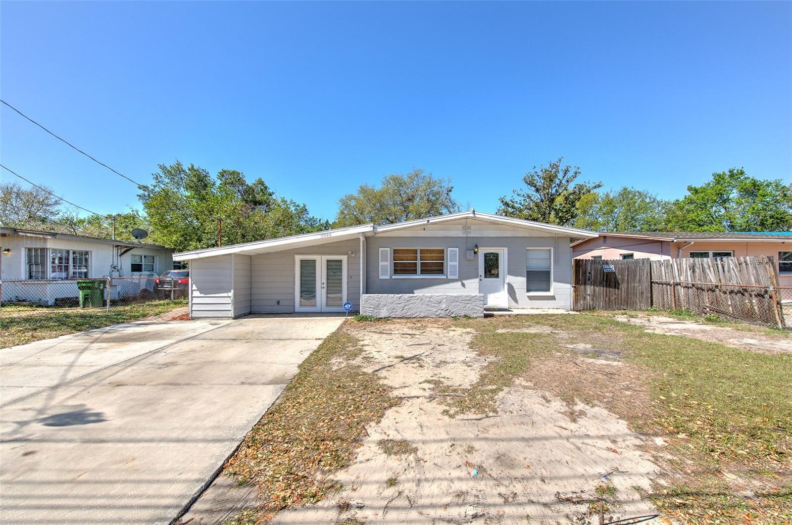 Welcome to this beautifully upgraded 4-bedroom , 2-bathroom block home that perfectly combines style, comfort, and functionality. The roof, HVAC system, and water heater were replaced in 2022. Inside, you'll find double pane windows, a spacious open floor plan with fresh interior and exterior paint, tile and vinyl plank flooring throughout for low-maintenance living, and renovated kitchen and bathrooms with modern finishes. The gourmet kitchen features new cabinets, quartz countertops, and stainless steel appliances. Both bathrooms are updated with matching quartz countertops for a cohesive and upscale feel. The spacious master suite offers elegant tile-accented walls, a private bath, and a huge walk-in closet. An additional 4th bedroom, office, or potential in-law suite is located beyond the master, complete with its own private entrance to the backyard—perfect for guests or working from home. Step outside to a fully fenced backyard with a paved patio, ideal for entertaining and enjoying Florida’s sunshine. The oversized driveway accommodates multiple vehicles with ease. Location perks: Walking distance to Copeland Park, schools, and public transportation. Minutes from I-275, I-75, Busch Gardens, USF, Zoo of Tampa, restaurants, shopping, and Tampa International Airport. In the highly regarded Wharton High School district. Copeland Park offers fantastic amenities just across the street: recreation center, pool, indoor/outdoor basketball courts, tennis courts, playgrounds, walking and nature trails, and more!