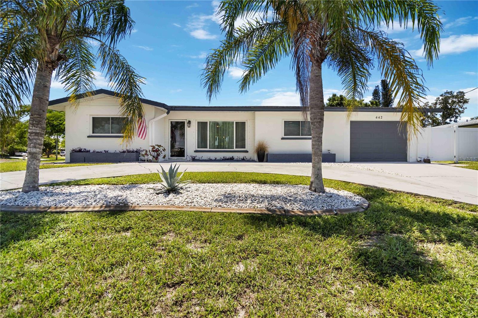 Welcome to this stunning 3-bed, 2-bath home with 1-car garage in sought-after Venice Gardens. This split floor plan features a spacious owner's suite with walk-in closet and brand-new tiled shower. Gleaming diamond-polished Terrazzo floors, 5 1/4" baseboards, updated ceiling fans, 2" white faux wood blinds, new raised panel interior doors, and fresh paint inside and out give the home a modern, clean feel. The galley-style kitchen boasts soft-close white shaker cabinets, quartz countertops, LG stainless steel appliances, and ample storage. Off the kitchen, the laundry room offers a new whirlpool washer/dryer, new hot water heater, storage closet and new exterior door. Relax in the light-filled Florida room with new tile flooring. The 1/4+ acre lot features vinyl fencing, a shed, and space for your outdoor oasis. *NEW ROOF 12/23* Flood zone X* No HOA/Deed Restrictions* Close to beaches, downtown, shops & dining. Beautifully furnished and Competitively priced - Don't miss this opportunity!