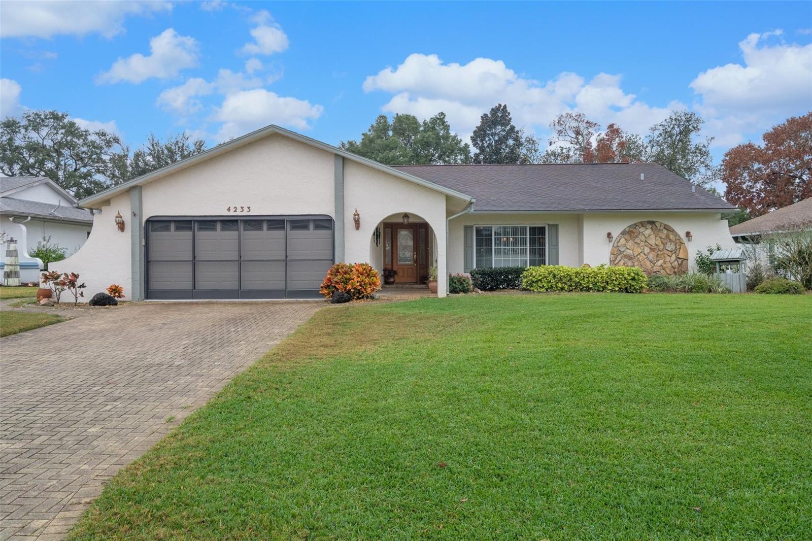 This impeccably maintained 2-bedroom, 2-bathroom split-floor plan home in Berkeley Manor is a true stunner, brimming with upgrades and ready to impress. Fully furnished and packed with thoughtful details, it's perfect for year-round living, a winter escape, or a lucrative AirBNB rental. Its prime location near shops, restaurants, Weeki Wachee Spring Park, and Hernando Beach adds another layer of allure.
Step through the grand frosted glass entryway with double side windows and prepare to be awed. An L-shaped living/dining room greets you, boasting a custom audio-visual wall showcasing a 65" TV and integrated sound system. Move past the foyer and discover a recently remodeled kitchen bathed in natural light from a skylight. Tray ceilings and recessed lighting set the mood, while ample storage options, including a dedicated pantry and spacious cabinets under a sprawling quartz countertop peninsula, cater to your culinary needs. Newer stainless steel appliances, including a 2021 Bosch dishwasher, complete the picture.
Three pocket sliding glass doors seamlessly connect the kitchen, living room, and primary bedroom to a luxurious screened pool area built in 2016. Imagine basking in the sun by the heated saltwater pool, enjoying cocktails at the outdoor bar with its TV, or unwinding in the inviting hot tub – all within your own tropical oasis. Lush, park-like landscaping further enhances the backyard haven.
The primary bedroom suite promises ultimate relaxation with private pool access and an ensuite bath featuring a spacious walk-in shower and dual vanities. The second bedroom resides on the opposite side of the home, offering privacy and convenience. A guest bathroom with a tub/shower combination completes the comfortable layout.
Step inside and be captivated by:
Gleaming tile and luxury vinyl plank flooring throughout
Textured Spanish lace walls adding a touch of elegance
Decorative archways enhancing the luxurious feel
Ample storage space in generous closets and throughout the home
A 2-car garage with handy storage cabinets
Outside, you'll be charmed by:
A beautiful paved driveway for easy arrival
Lush landscaping that creates a picturesque setting
Fresh exterior paint applied within the last two years
A convenient storage shed for all your gear
Sustainability and efficiency are also prioritized:
Double-pane insulated windows for optimal climate control
Smart irrigation system drawing from a private well
Smart thermostat for effortless temperature management
New water heater installed in 2023
Updated HVAC system with improved ductwork and UV air handler purification
Convenient inside laundry area with sink and cabinets
This exceptional home isn't just a place to live – it's an invitation to experience Florida living at its finest. Don't miss your chance to make it your own!