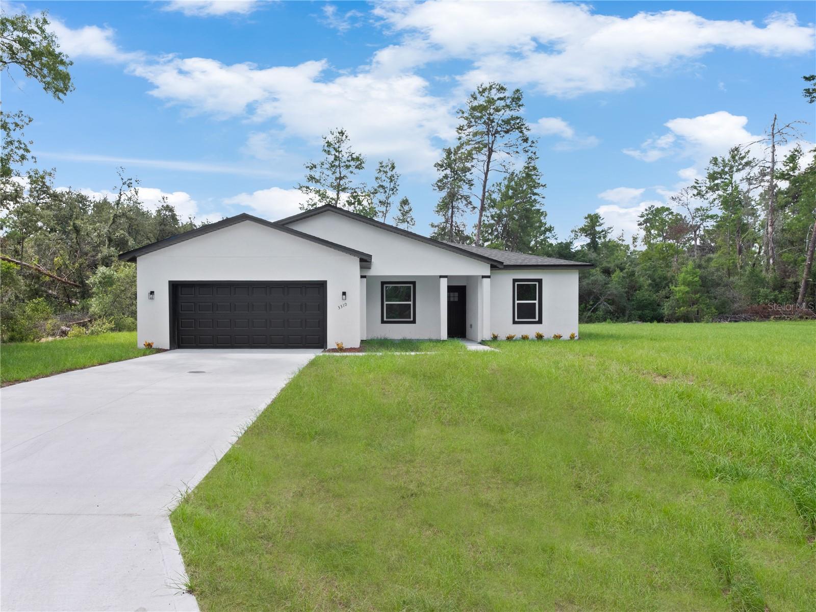 Stunning new rental in Ocala! This contemporary 4 bedroom, 3 bath home with a bonus Den/Office room offers an open floor plan with 9-ft ceilings, recessed lighting, and smooth laminate flooring throughout the main living areas. The gourmet kitchen features a waterfall island with pendant lighting, soft-close cabinets and drawers, Whirlpool stainless steel appliances, and a unique coffee bar area. The primary suite boasts a spa-style bath with walk-in shower, soaking tub, and a walk-in closet. Additional highlights include a linen closet, front porch, and back porch for perfect outdoor gatherings. Located in the heart of Ocala, known as the Horse Capital of the World, you'll enjoy scenic parks, crystal-clear springs, equestrian trails, and a welcoming community with a lower cost of living than many Florida metros. This rental won't last long schedule, a showing today!