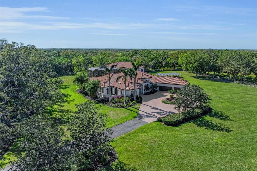 Welcome to this extraordinary custom-built John Cannon estate, where seclusion, luxury, and modern convenience merge flawlessly. Located just minutes from I-75 and I-275, and five minutes from the rapidly growing North River Ranch with brand-new schools, medical facilities, restaurants, and more, this lovely 5 acre masterpiece is sure to impress with 4 bedrooms, 4.5 bathrooms! The perfect blend of elegance and practicality with the freedom that comes from NO HOA or CDD. Freshly painted interior and exterior, along with energy-efficient features like a modern tankless water heater and ground-mounted solar panels, ensure comfort and sustainability. The open floor plan is perfect for both relaxing and entertaining. The gourmet kitchen with sub-zero and induction stove flows seamlessly into the expansive great room and dinette, perfect for hosting guests. Enjoy added luxury with a soundproof theater room, a library with built-in bookcases, and BONUS ROOM or a possible 5th bedroom. Outdoors, the tropical entertainment area with salt water pool and spa, offers the ultimate in privacy and relaxation. Fenced dog yard with synthetic grass, lush landscaping including majestic oaks and a statue garden are just a few extras. Nature lovers will delight in the adjacent 2,000-acre Terra Ceia State Preserve, perfect for birding, fishing, and hiking, while horse lovers will enjoy the world-class equestrian facility offering programs for riders of all ages within walking distance. The easy access to St. Petersburg, Tampa, Orlando and Sarasota makes this the ideal location on the gulf coast. This is more than just a home - it’s a lifestyle, where every day feels like a vacation. With OWNER FINANCING available, don’t miss your chance to own a piece of Florida’s finest real estate. Live the dream today!