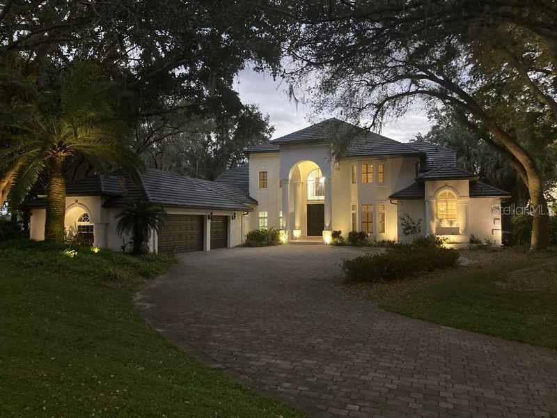 Beautiful Windermere Chain of Lakes Estate.. This Lake Down waterfront two story custom home consists of (4 Bedrooms plus Office).
Located on two incredible acres of lakefront with spectacular views of the fabulous Lake Butler Chain of Lakes.
Upon entering the home you are greeted to a wonderful view of the lake through the two story cathedral windows in the grand living area with large stone fireplace. Large chef style kitchen with cooking island and large counter tops overlooking the gracious backyard.
First floor large master suite with French doors leading out to the resort style pool, spa and outdoor sitting area with fireplace.
With over 4000 sqft. of Travertine flooring makes this the perfect home for lakefront living.
There is a Large bonus room with fireplace for added entertainment.
Upstairs consists of three large bedrooms with high ceilings and fans.
Property comes with a Covered dock w/boat hoist allowing you to enjoy one of Florida’s finest fresh water chain of lakes.
Come enjoy the life style... Room Feature: Linen Closet In Bath (Primary Bathroom).