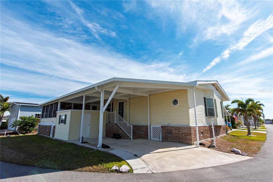 Welcome to this desirable 55+ community in Windmill Village! This spacious 2-bedroom, 2-bathroom home offers 1,508 square feet of furnished living space in the sought-after 2006 Adrian model. Located on a corner lot, the home features an open concept layout, including a bright and airy living room, formal dining area, and a dedicated office space. The main living areas and bedrooms are adorned with crown molding and drywall for a clean, modern look. The large kitchen is a standout, with ample wood cabinetry and plenty of counter space for meal preparation. Ceiling fans throughout help keep the space comfortable. Home boasts a new roof in 2022 and a new AC in 2023. Step outside to enjoy the expansive 386 square-foot L-shaped front porch, perfect for relaxing or entertaining. The front porch is built with extra insulation and energy-efficient glass windows, ensuring comfort year-round. A large storage shed provides additional space for your belongings, and hurricane shutters on all windows offer peace of mind during storm season. This home is the perfect blend of comfort, style, and convenience! HOA of $261.00 covers water, sewer, trash, grass maintenance, common area upkeep, and road maintenance, ensuring a hassle-free lifestyle for residents. Don't miss your chance to experience the comfort and convenience of waterfront living in this meticulously maintained home at Windmill Village!  This active lifestyle community features two private marinas, boat ramp, trailer storage yard, horseshoe pits, shuffleboard, bocce ball, billiards, indoor pickleball, a large community center and many clubs catering to your hobby interests. The Pavilion by the heated pool offers an area for holding gatherings. Punta Gorda was voted “#1 Best Small Place to Live” by Money Magazine and Forbes. Purchase price does not include $18,285.00 for Buy-In Share and Bond, which is refunded when you sell. Don't miss the opportunity to make this thoughtfully upgraded and beautifully maintained home in Windmill Village yours! Schedule your showing today-this is your paradise.