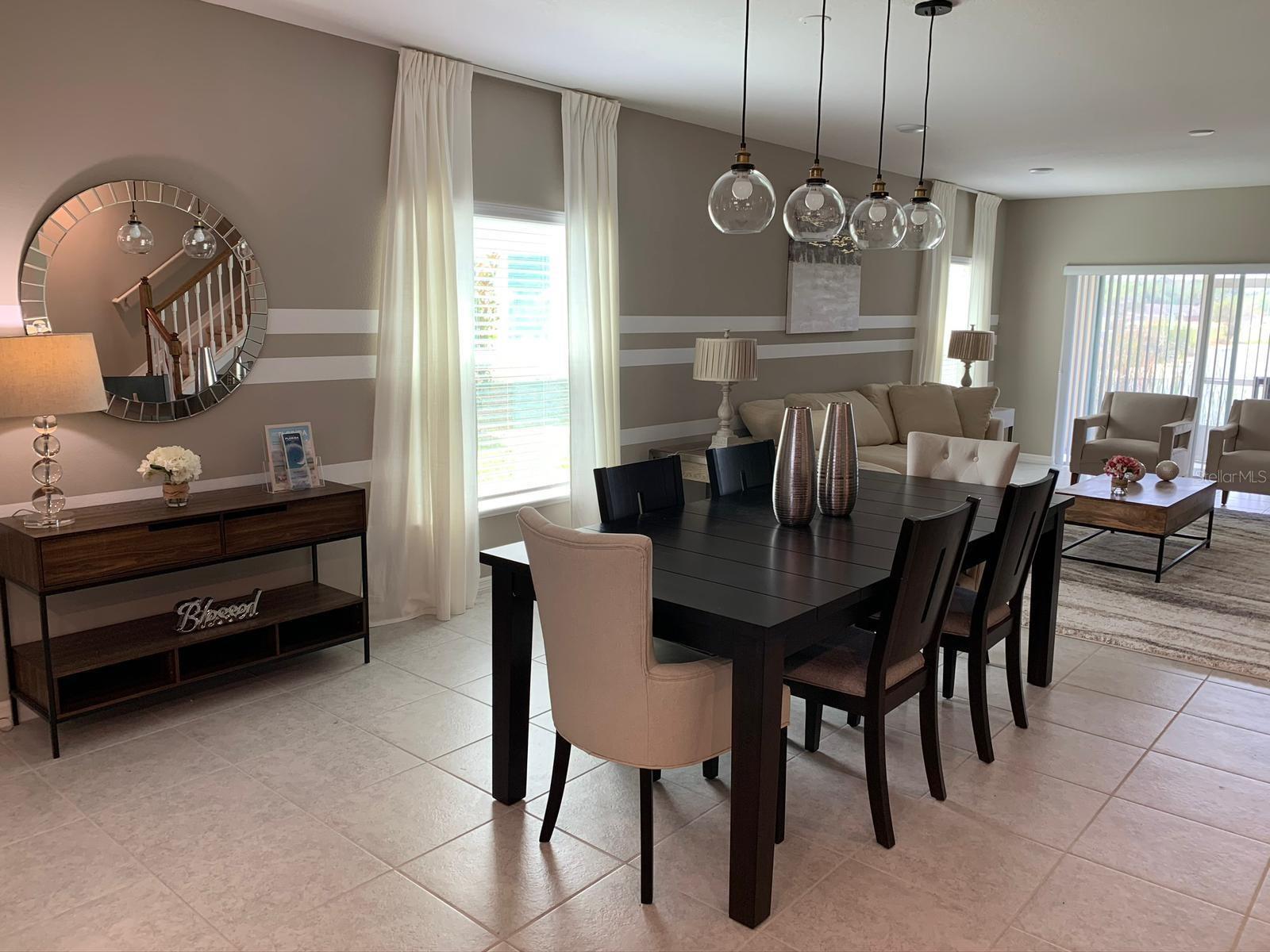 Welcome to this stunning corner-unit townhouse located in the desirable gated community of Fiesta Key, just minutes from Disney Parks, top restaurants, schools, hospitals, shopping centers, and the SunRail station.Step inside to discover a bright open floor plan that seamlessly combines the dining and living areas, creating a warm and inviting space. The modern kitchen is fully equipped with stainless steel appliances, a spacious island perfect for entertaining, a breakfast bar, and a pantry. A convenient powder room and a screened-in back porch with an additional storage room complete the first floor.Upstairs, you’ll find a beautiful master suite featuring two walk-in closets and a private master bathroom with dual vanities and a walk-in shower. Two additional bedrooms share a full bathroom, and the laundry area comes equipped with a washer and dryer for your convenience.Residents of Fiesta Key enjoy fantastic community amenities, including tennis courts, two sparkling pools, and a clubhouse.This property offers flexible use as a long-term rental, short-term rental, vacation home, or primary residence—making it an excellent investment opportunity.Don’t miss your chance to own this exceptional home. The seller is motivated, so schedule your showing today!