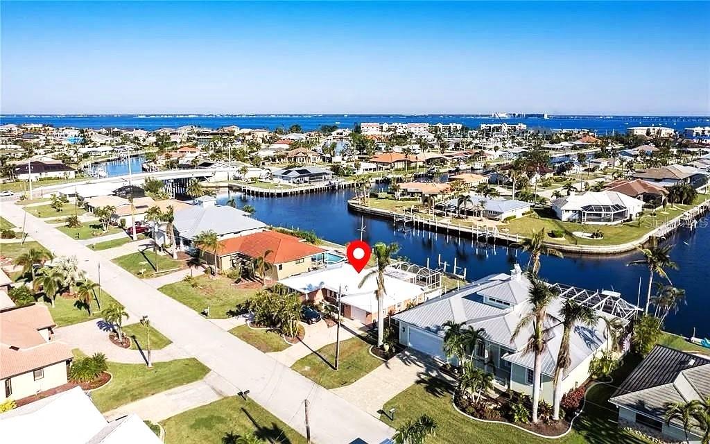 PUNTA GORDA ISLES WATERFRONT GEM!
Live the ultimate Southwest Florida boating lifestyle in this beautifully updated 3-bedroom, 2-bath waterfront home offering just 10 minutes in and out to open water — giving you quick access to Charlotte Harbor and the Gulf of Mexico! Featuring 80 feet of waterfront, intersecting canal views, concrete seawall, private dock, and boat lift, this property is a true boater’s paradise.
Step inside to discover a bright, open layout with tile flooring throughout, crown molding, and elegant spaces perfect for entertaining. The modern kitchen boasts granite countertops, custom wood cabinetry, stainless-steel appliances, and a breakfast bar pass-through to a flexible bonus room ideal for dining or a family room.
The primary suite offers a private bath, walk-in California closet, and access to a fenced side yard—a quiet retreat for morning coffee or evening relaxation. Guests enjoy privacy with the split-bedroom floor plan, generous guest rooms, and a full bath.
Outdoors, enjoy year-round living on your large screened lanai, surrounded by lush tropical landscaping and two fenced areas—perfect for pets or gardening. Additional highlights include a metal roof, impact windows, circular driveway, and a 1-car air-conditioned garage. A/C replaced in 2018.
Ideally located in the heart of Punta Gorda Isles, a world-class boating and golf community, just minutes to the Yacht Club, Fishermen’s Village, and historic downtown Punta Gorda with its dining, boutique shopping, and vibrant waterfront entertainment. Convenient to I-75 and the beautiful Gulf beaches of Southwest Florida.
Move-in ready, perfectly maintained, and offering fast open-water access — your dream waterfront home. MORE PHOTOS ARE COMMING SOON!
