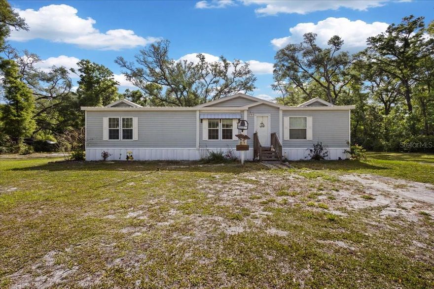 Gorgeous custom 2019 DWMH located on 2.39 acres in the gorgeous countryside of Dixie County. This home is conveniently located on a paved road just minutes to Old Town or Cross City Florida. A beautiful open canvas to make your very own. The manufactured home is in brand new condition and offers a beautiful bright open floor plan. 3 bedrooms and 2 bathrooms , as you enter you are greeted with a open floor plan with a spacious living room, spacious dining room and open kitchen with tons of cabinetry , stainless steel appliances , Custom ceiling detail and beautiful crown molding throughout the whole home. Laminate wood flooring throughout the main living areas and carpet in the bedrooms. A spacious laundry/utility room. Master bedroom is oversized with a large walk in closet and one amazing master bathroom. Custom shower with multiple shower heads, dual vanities and a jacuzzi tub. Each guest bedroom is spacious and share a guest bathroom. Outside you will fall in love with the back porch. A gorgeous back porch spanding nearly the full length of the home. An above ground vinyl pool and a big gorgeous yard to offer tons of privacy ! This home easily qualifies for ALL Loan types, call today for YOUR tour!