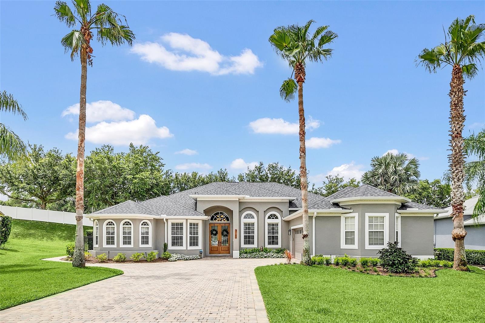 Welcome to the private gated community of Forestbrooke Estates and to this stunning one-story home offering outstanding curb appeal and a convenient location on a cul-de-sac of Daymark Terrace. Prepare to be amazed the moment you enter this exceptional 5 bedroom, 3.5-bathroom property with new 8-foot luxury front doors and 8-foot luxury French doors that lead you to a back yard paradise; the fenced backyard oasis captivates with the breathtaking saltwater pool, where contemporary water bowl fountains add elegance to the picturesque pool setting, a gorgeous lanai area is complemented by the stand-alone heated spa, a rock garden wall with Florida friendly plants, and there is a shaded sitting area to watch TV & enjoy the outdoors. Additionally, the outdoor kitchen, complete with a grill/stove and wet bar, is sure to impress. This home is equipped with Sunrun solar that powers the home all day & charges the two Tesla powerwalls that run the home all night and during storms. Imagine almost no electric bills! Other luxury upgrades include UV filters on both HVAC units to keep the air pure, Imolaza smart sprinkler controls for the irrigation system, Nest thermostats, U-tec smart lock (use your key, code, or fingerprint to access the home), home ADT security, newer interior and exterior paint (2022), combination whole home water softener and filter, and no carpeting anywhere. Also, it offers exterior pavers and a side paver walk-way. The interior has all new light fixtures and ceiling fans, newer hinges and doorknobs, and newer window treatments, as every room is adorned with stylish details. The kitchen is a culinary masterpiece, featuring stunning granite counters, stylish subway tile backsplash, an island, breakfast bar and nook, rich 42" cabinets, & high-quality stainless-steel appliances and there is an additional refrigerator in the garage that stays. The kitchen seamlessly flows into the bright, airy, and spacious family room, and for special occasions the formal living & dining areas provide the perfect gathering area. The master suite is truly remarkable with a generous walk-in closet, an additional closet, and an en-suite bathroom is a haven of relaxation boasting a luxurious jetted garden tub, separate vanities, shower stall, and a private lavatory. Adjacent to the master suite is the 5th bedroom, which features custom woodwork and can serve as an office, nursery, or home gym. A guest suite is conveniently situated off the family room and offers outdoor access. The home is a "triple split bedroom plan" with the two charming additional bedrooms sharing a Jack and Jill bathroom. The inside laundry room provides ample space and has a new (2022) pet-friendly utility sink, and the double car garage includes storage racks above the cars. The low HOA fees cover access to peaceful parks and a community pool, while the proximity to the 429 ensures easy commuting, close to the Publix shopping center, with downtown Winter Garden just a short 15-minute drive away. Also, don't forget to explore the nearby community amenities: playground, clubhouse, and pool. Disney and Universal Studios are just 25 minutes away! No are NO rental restrictions, and short-term rentals are allowed - verified by the HOA. *Please note: enter the development from the gate on Summershade, room measurements are approximate and should be verified independently, the RO system under the kitchen sink does not stay, and Buyer must assume the Tesla /solar remaining balance.