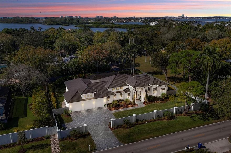 Welcome to 4050 Camino Real, a stunning property that seamlessly blends luxury and comfort. This exquisite, almost new, property boasts a prime Oyster Bay area location with picturesque surroundings, making it an ideal haven for those seeking both tranquility and convenience.
As you enter this meticulously designed residence, you are greeted by an impressive foyer that sets the tone for the entire home. The 16 foot ceilings and 10 foot pocketing sliders connect the inside living areas to the fabulous lanai.  The expansive living spaces are bathed in natural light, creating an inviting atmosphere for relaxation and entertainment. The open-concept layout seamlessly connects the living, dining, and kitchen areas, providing a perfect setting for gatherings and family moments.  The gourmet kitchen is a chef's delight, featuring Monogram appliances, Quartzite and honed Quartz countertops, custom shaker cabinetry, and ample storage space in the walk in pantry. Whether you're preparing a casual meal or hosting a lavish dinner party, this kitchen is sure to inspire culinary creativity. The master suite is a sanctuary of indulgence, offering a spacious retreat with a spa-like ensuite bath, built out closets and custom wall woodworking. The additional bedrooms are all en suite, split across the home and provide comfort and versatility, accommodating the needs of a growing family or guests. The whole home has wide plank French Oak flooring by DuChateau.  Each room is thoughtfully designed to maximize space and functionality. The home also features LuTron smart home technology with lots of built in speakers, lighting and cameras. Step outside to discover a private oasis, complete with meticulous landscaping, a refreshing saltwater pool and spa, and outdoor living spaces perfect for al fresco dining or simply enjoying the Sarasota sunshine. The property's curb appeal is enhanced by its architectural elegance and attention to detail. The home also features a number of green upgrades including impact windows and doors, a whole house generator, a well for irrigation, Icynene spray foam insulation, and an EV car charging outlet in the garage.  4050 Camino Real is not just a residence; it's a lifestyle. With its proximity to local dining, parks, cultural attractions, and some of the nations best beaches, this home offers the best of both worlds – a serene escape and easy access to the vibrant city life. Don't miss the opportunity to make this exceptional property your own. Schedule a showing today and experience the epitome of luxury living. Bedroom Closet Type: Walk-in Closet (Primary Bedroom).