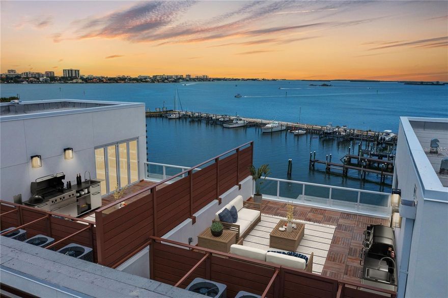 Experience elevated waterfront living in this exceptional new construction townhome offering stunning sunset views and direct access to a private marina. Thoughtfully designed with both style and function in mind, the residence features a striking white-oak floating staircase and a private elevator providing seamless access to every level. Soaring tray ceilings with accent lighting, luxury vinyl plank flooring, and an open-concept layout create a bright, modern feel, complemented by expansive balconies that showcase beautiful water views. The chef-inspired kitchen is ideal for entertaining and everyday living with a five-burner gas cooktop, built-in oven and microwave, a large pantry, solid wood shaker cabinetry with pull-out shelving, expansive quartz countertops with a breakfast bar, and a wine refrigerator. The primary suite is a private retreat with its own balcony, dual walk-in closets, and a spa-style ensuite featuring double vanities and a spacious walk-in shower with frameless glass. Water views can be enjoyed from nearly every vantage point, and the rooftop level truly sets this townhome apart, featuring a bonus room and second kitchen, folding glass doors that open to a patio with an Ipe wood deck, and a built-in gas grill with cabinetry, perfect for entertaining or relaxing while enjoying the sunsets. Additional highlights include a two-car garage and a large storage room, all conveniently located just minutes from downtown Dunedin, approximately one mile from the Dunedin Causeway, and about a 20-minute drive to Clearwater Beach, with Tampa and St. Petersburg both roughly 35 minutes away.