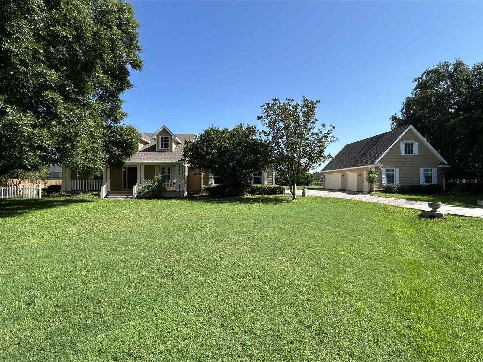 Southern Charm vibes through out this unique property. The huge front porch welcomes comfy rockers to enjoy the shade of the cul-de-sac front yard. Full paver driveway connects the main house two car garage to the detached additional three car or workshop (30' x 40') with full loft storage space that is ready for new owner's dreams and creativity.
Grand foyer leads you into a spacious open family room with an impressive granite island that bridges the chef-size kitchen to this open concept space. The inviting back porch has so many features including a full screened cage over 22 x 41 full paver space that is perfect for entertaining. This space features a overhead cool misting system.
Plantation shutters, new Alder interior doors, new front door, new master suite exterior door, compete new interior paint, bathroom renovations are just a few of the new upgrades. Recent replacement of both AC units. Whole house central vacuum system. This home was was a custom build by one of Osceola County's most premier builders, Barry Bryant. Quality craftsmanship shows in every corner of the home. The house features a wall tube pest treatment system that is maintained by a local pest control company on a yearly basis.
Hickory Hollow community is such a hidden gem! Many residents enjoy the community private entrance gate feature for drop off and pick up of their elementary age students. Golf carts are often seen being used in this community including in the annual Christmas Parade. When the cooler weather allows many residents gather for a treat of neighborhood fellowship and open invitation to enjoy the selected food truck on one of the many neighborhood cul-de-sacs. Semi-annual community yard sales. Several neighborhood ponds are favorite fishing holes for catch and release fun.