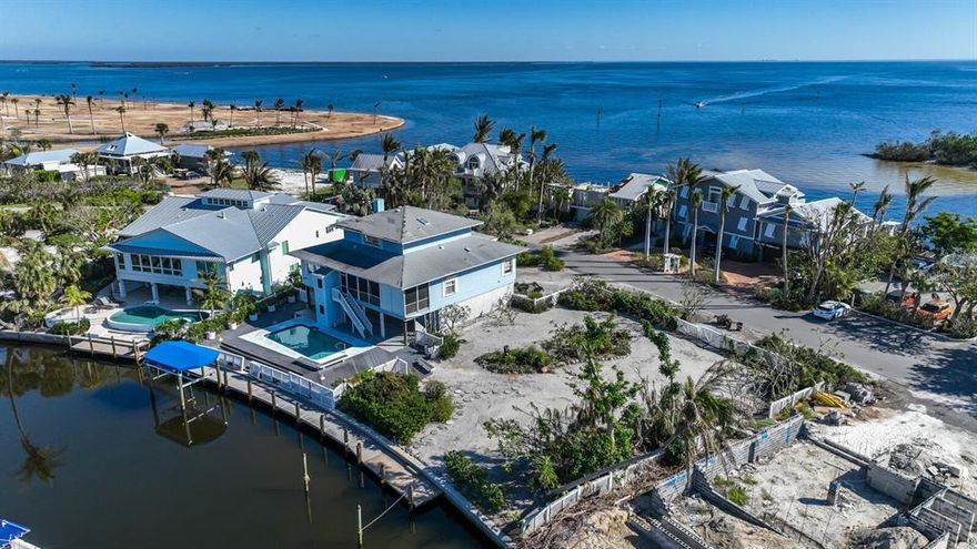 This prime property is located on desirable Harbor Drive in the Waterways district of the charming Village of Boca Grande. The home features beautiful views of the Bayou, an inground pool, a newer dock and covered lift.  The home suffered damage from hurricane Ian and is being sold "AS-IS".  You can renovate to suit your needs. The front of the property has Eastern exposure that will allow you to enjoy views of the morning sunrise over Charlotte Harbor from the deck.  The rear of the property and pool have Western exposure, so you can take in the colorful sky as the sun goes down. Once in lifetime location!