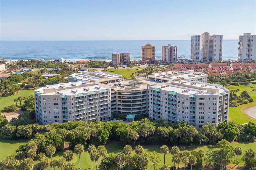 Be mesmerized by this meticulously detailed, must-see condo in the heart of all that Daytona Beach Shores has to offer. Professionally remodeled in a bright, coastal-chic motif with designer decor and furnishings, this convenient drive-to-your-floor condo is among the best available on the beachside. Find light and bright LVP flooring throughout the residence and an open, airy gourmet kitchen that features an island butcher block and wine cooler, two inch maple countertops, a black ceramic kitchen sink, and white shaker cabinets with striking gold handles. Enjoy the peace of mind of high-end appliances including a 36 inch Kenmore refrigerator, a Whirlpool exhaust and microwave, a Whirlpool double oven with 5 burners, and a Bosch silent dishwasher. Upgrades abound, with a full list available upon request, but you won't want to miss the Sputnik chandelier, an electric fireplace with bar section, Walnut fluted mobilier and accent walls with integrated lights, and a spa-like primary bath that is a true showstopper. Living at Cloverleaf North places you in a prime location just steps from river and beach activities, golf, shopping, dining, tennis, pickleball and more. Park on your floor in the drive-up garage and enjoy community amenities that include both an indoor and outdoor swimming pool, a sauna, spa, and a fitness room. Come view today and elevate your beachside lifestyle to new levels.
