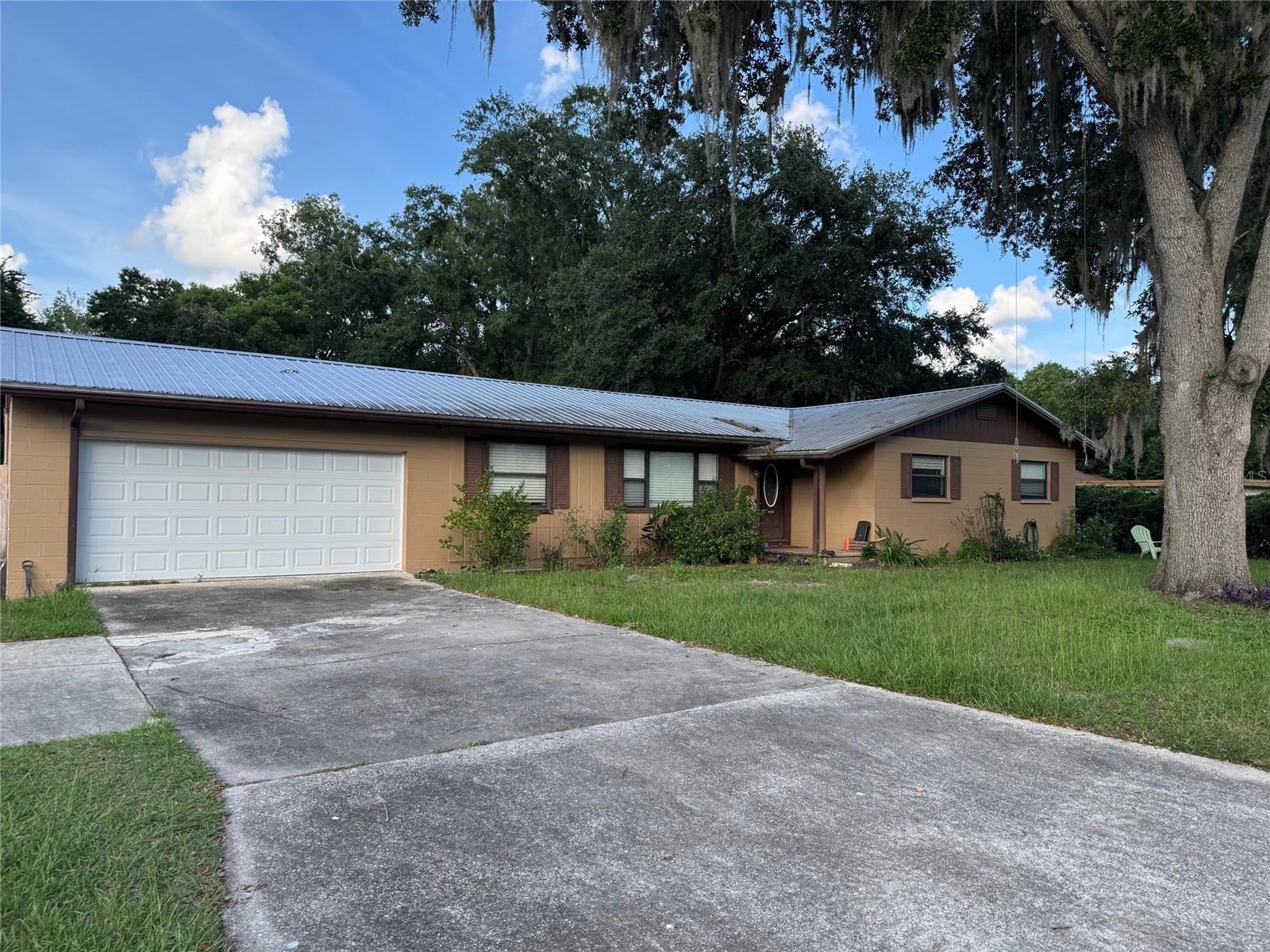 4 Bedroom, 3 Bath split level home on more than a half acre in the middle of everything! 3/2 upstairs with a bonus room with full bath downstairs with its own entrance which could be rental, Air B & B, or teen suite. Huge fenced back yard overlooks creek for total privacy. LOTS of potential here with one of the largest homes in the neighborhood!